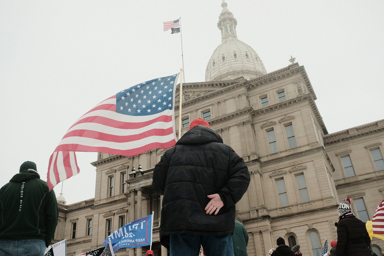 Supporters of President Donald Trump join in a mass prayer out front of the Michigan State Capitol Building to protest the certification of Joe Biden as the next president on January 6, in Lansing, Michigan. 