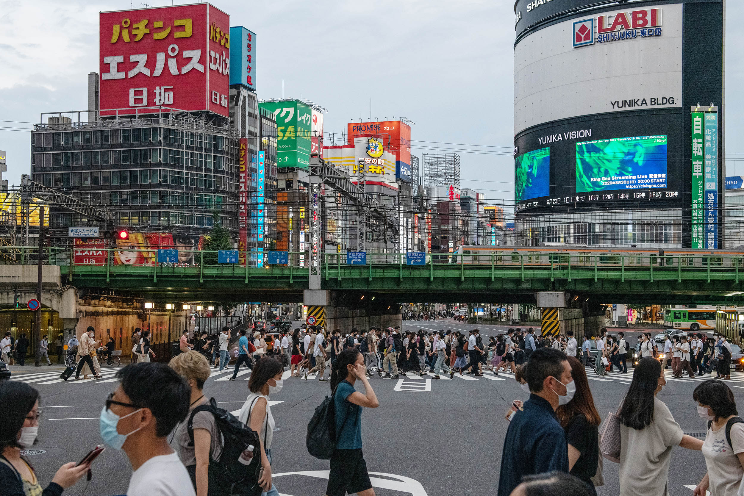 People cross a road on August 17, in Tokyo, Japan. 