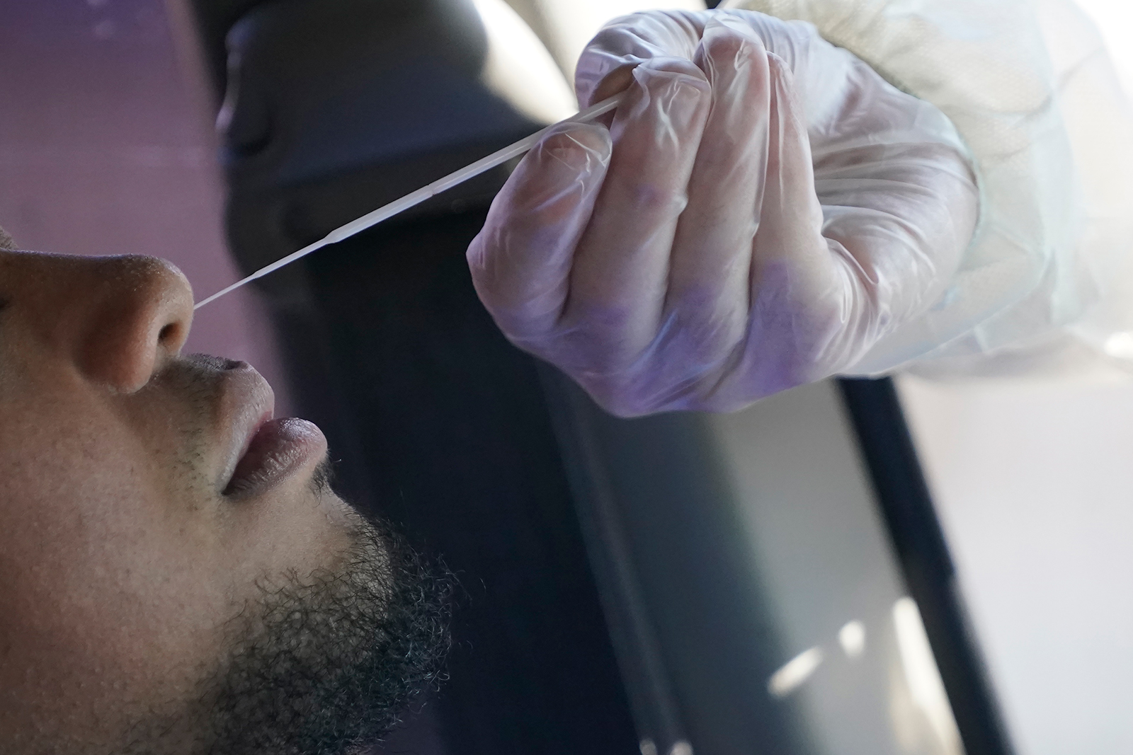 A Salt Lake County Health Department public health nurse performs a coronavirus test outside the department in Salt Lake City on Tuesday, November 3.