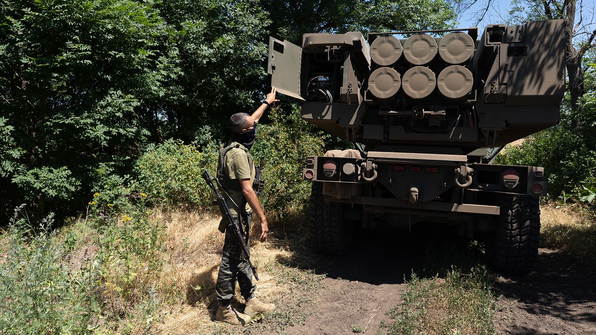Unit commander Kuzia shows the rockets on HIMARS vehicle in Eastern Ukraine on July 1, 2022.