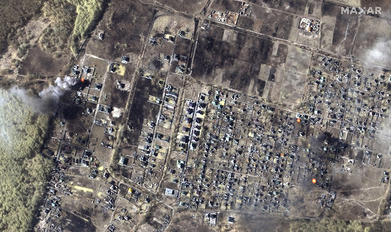 A color infrared satellite image shows burning homes in Moschun, Ukraine.