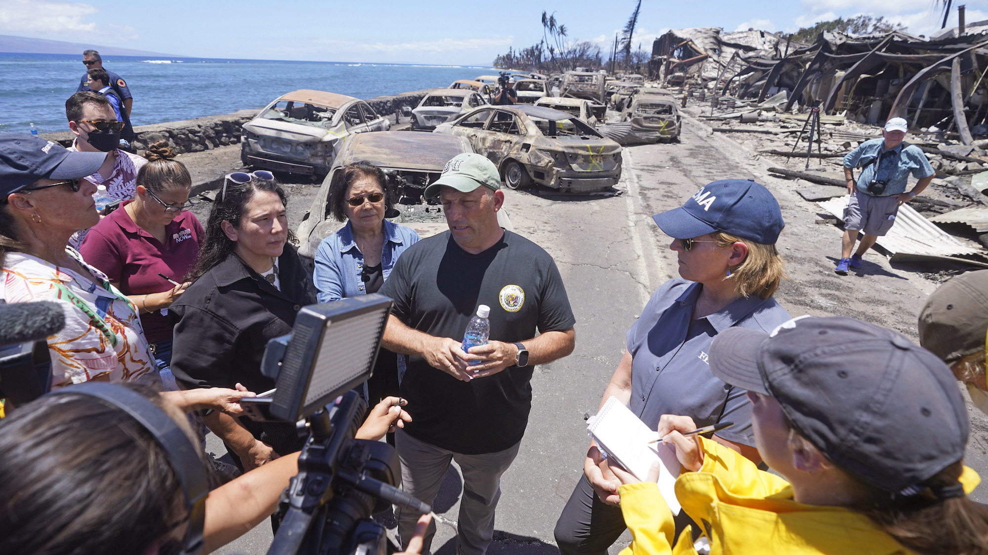Hawaii Gov. Josh Green speaks to reporters during a tour of wildfire damage on Saturday in Lahaina.