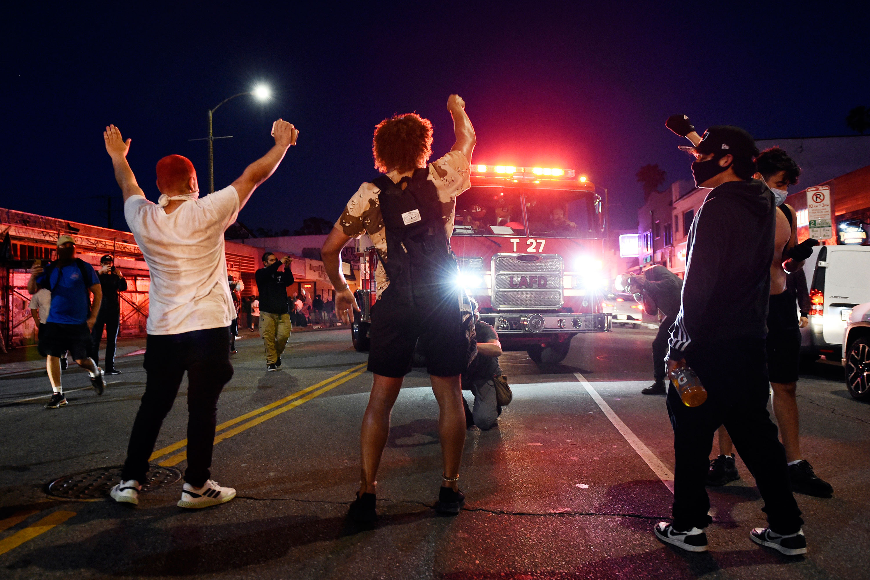 Demonstrators stand in the middle of Melrose Avenue on Saturday night in Los Angeles. 