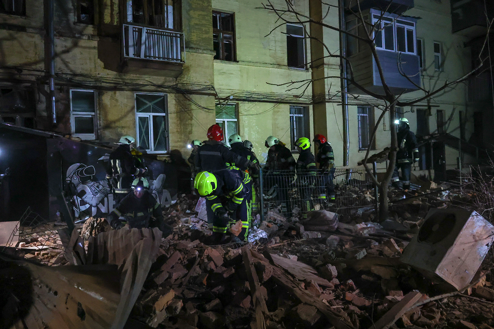 Ukrainian rescue workers disassemble the damaged structures of a building in the center of Kharkiv on Monday.