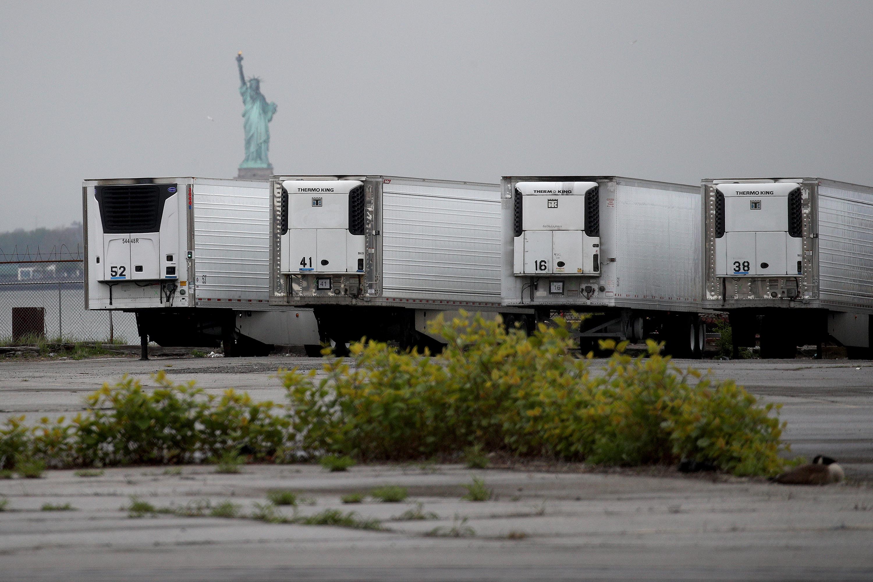 Refrigerated trucks functioning as temporary morgues for coronavirus victims are seen at the South Brooklyn Marine Terminal in New York City on May 6.