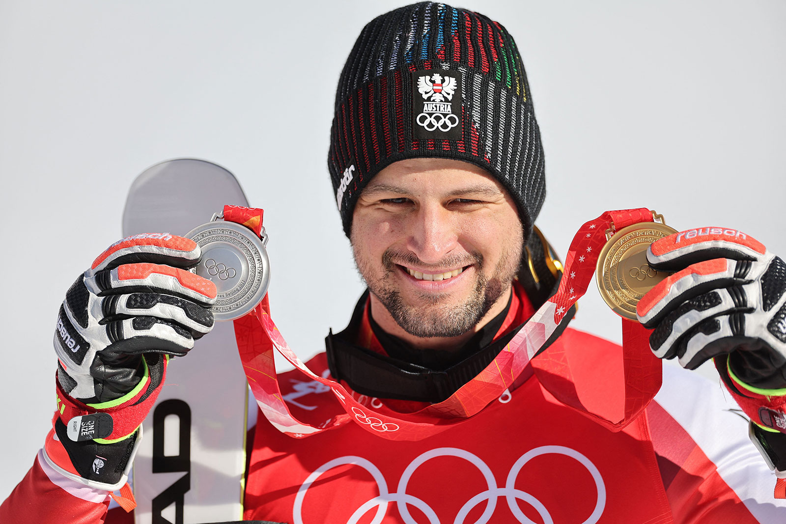 Austria's Johannes Strolz holds up his silver medal for the men's slalom and gold medal for the Alpine combined on February 16.