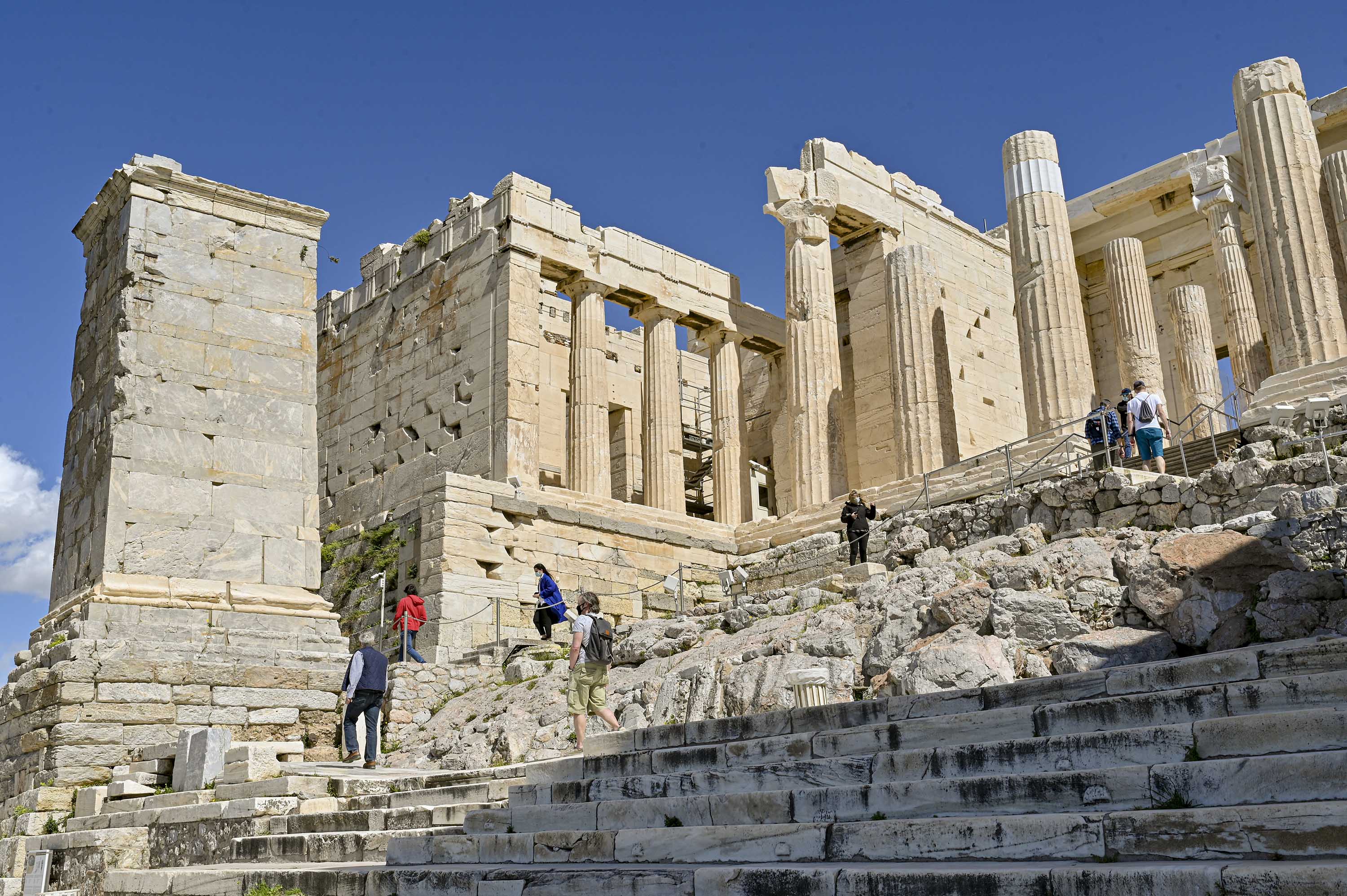 Visitors tour the the Athenian Acropolis on March 22, in Athens, Greece, after the site was reopened following the lifting of coronavirus restrictions.