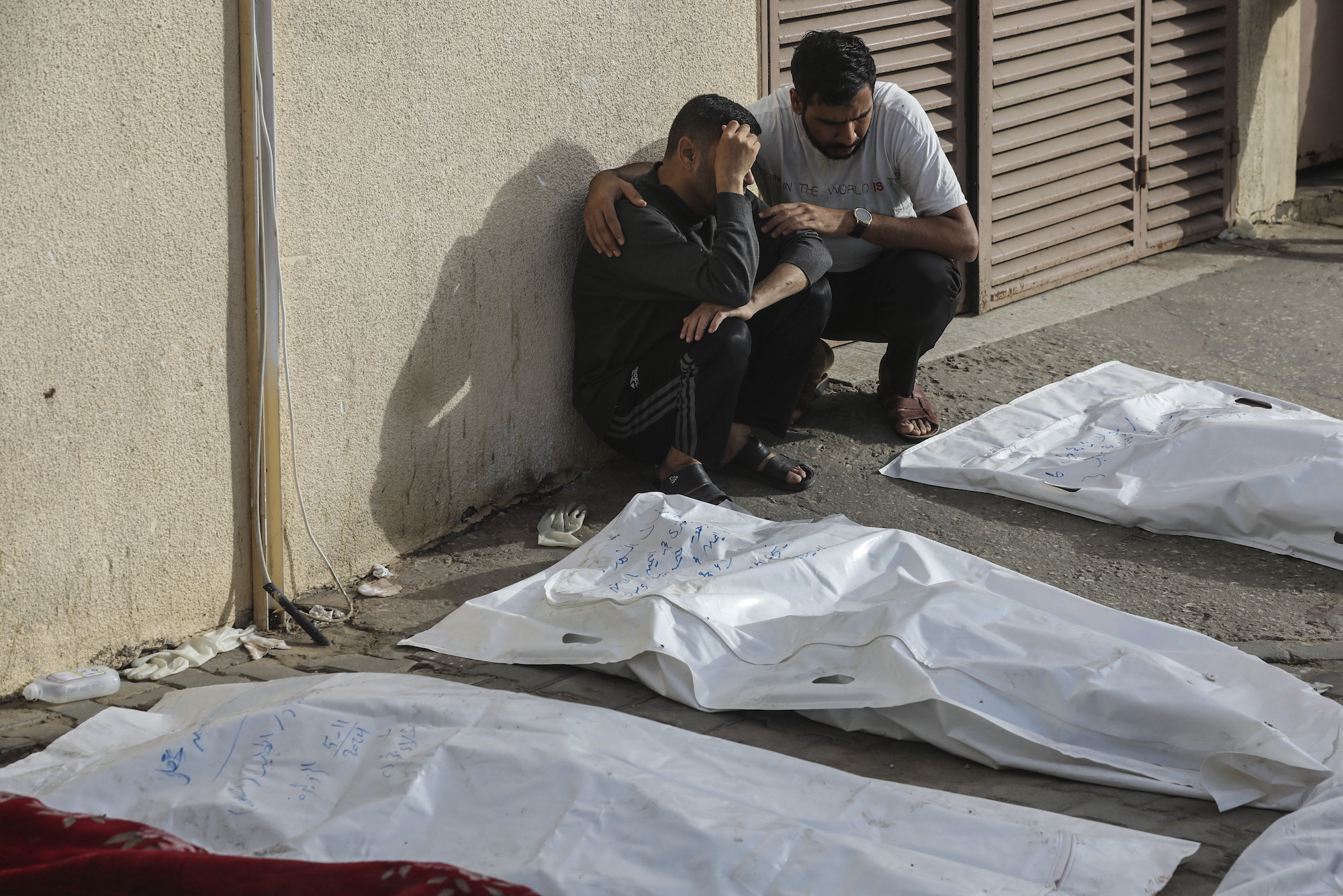 People mourn next to the bodies of Palestinians killed in an Israeli strike in Deir al-Balah, Gaza, on May 11.