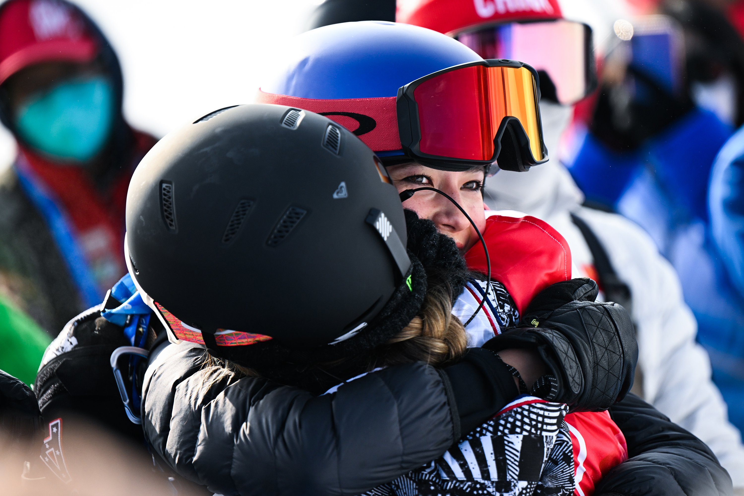 Chloe Kim celebrates with Eileen Gu after winning the gold medal during the women's snowboard halfpipe final on Thursday.