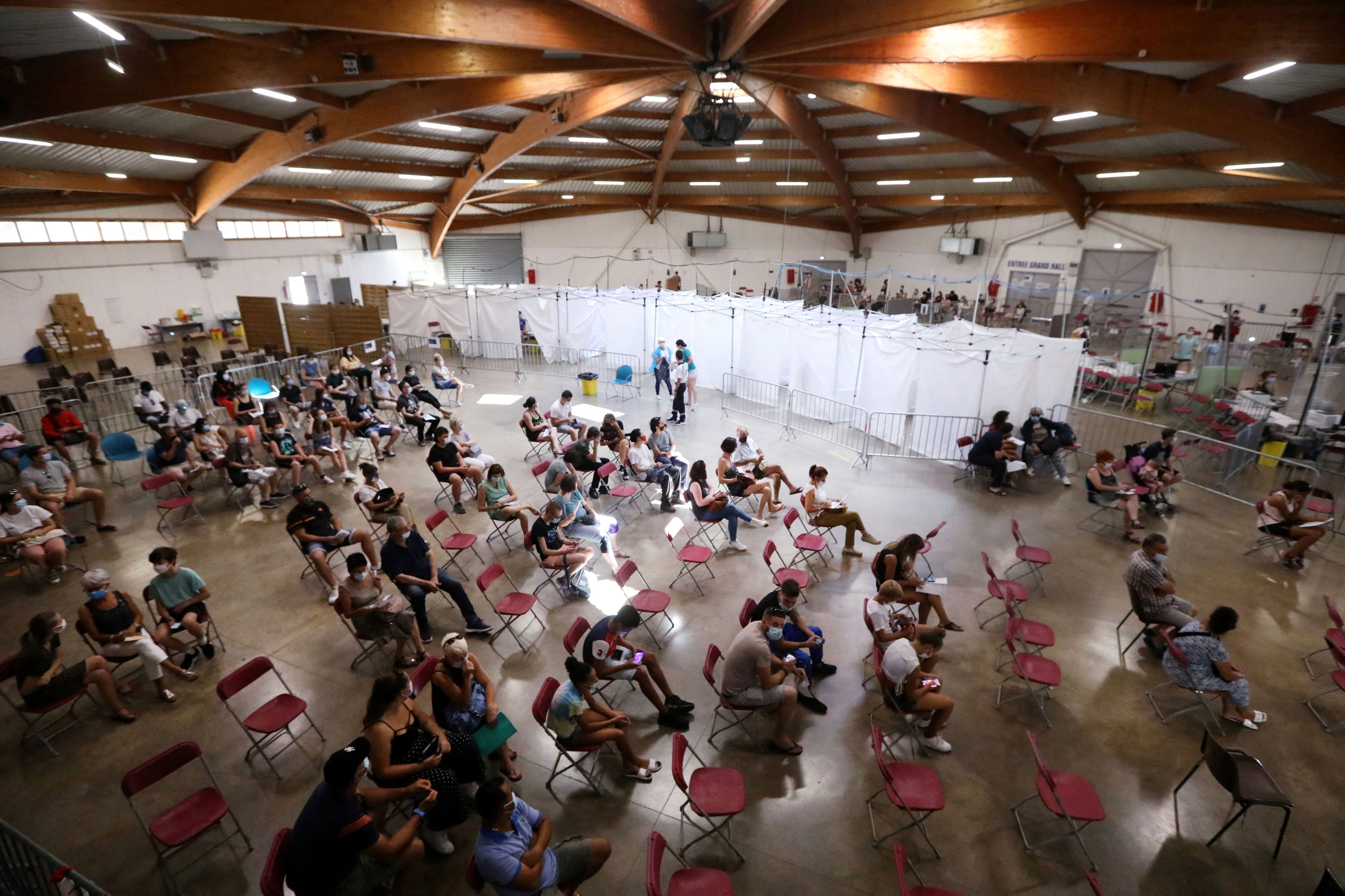 People wait to receive a dose of a Covid-19 vaccine at a vaccination center in Perpignan, France, on July 18.