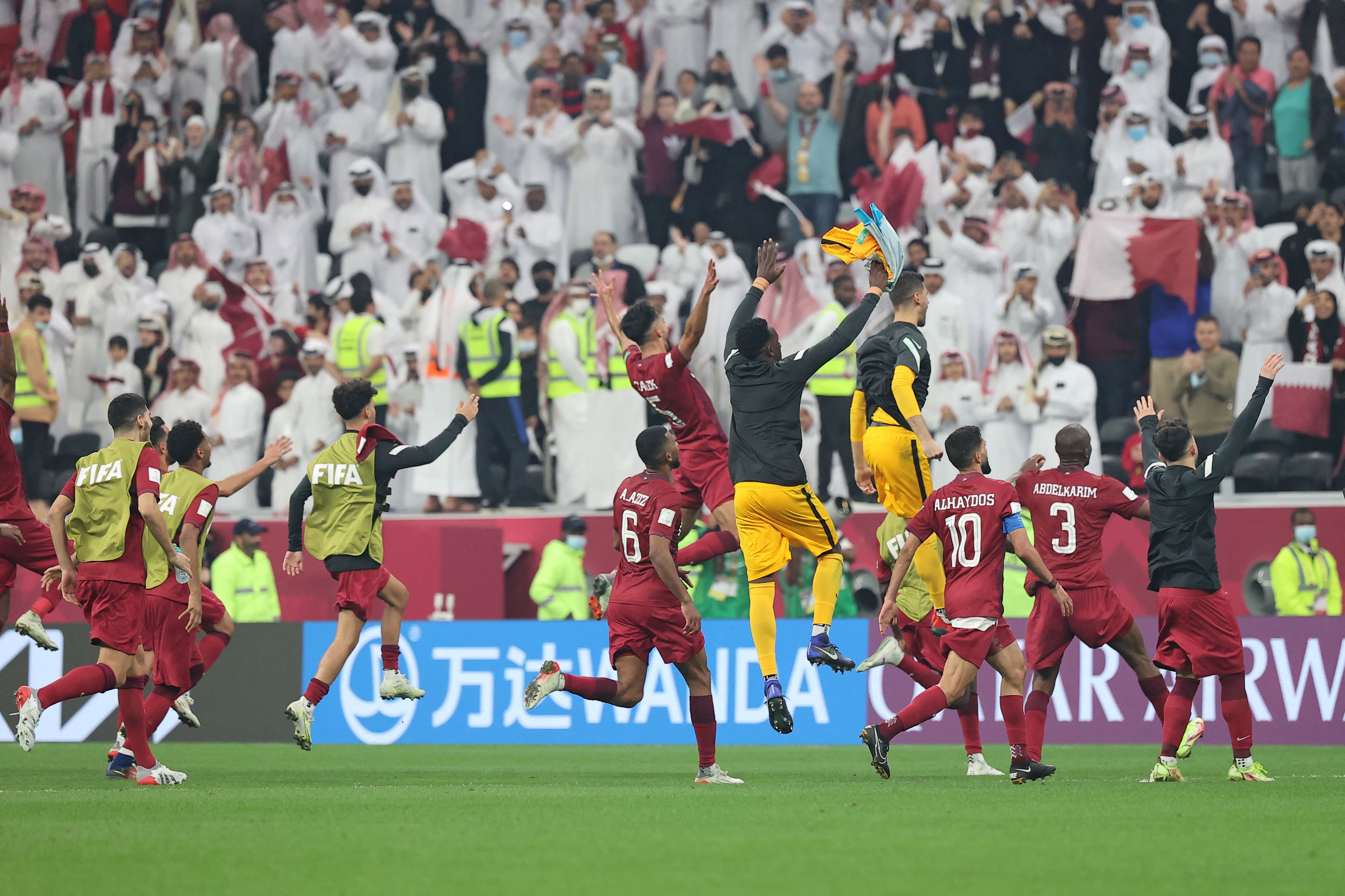 Qatar's players celebrate after beating the UAE in the 2021 Arab Cup quarterfinals.