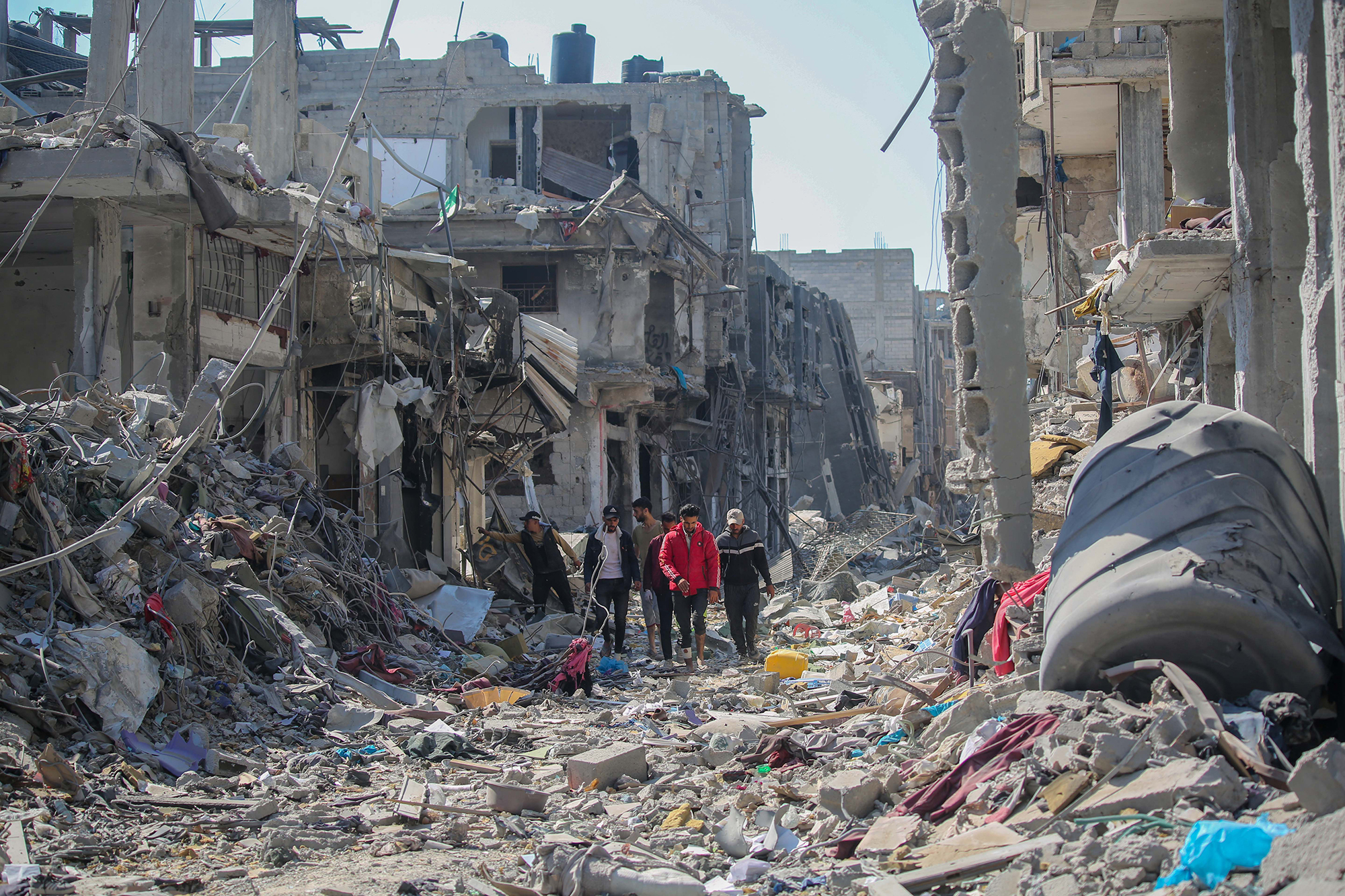 Residents inspect damage and remove items from their homes in the Gazan city of Khan Younis on April 7.