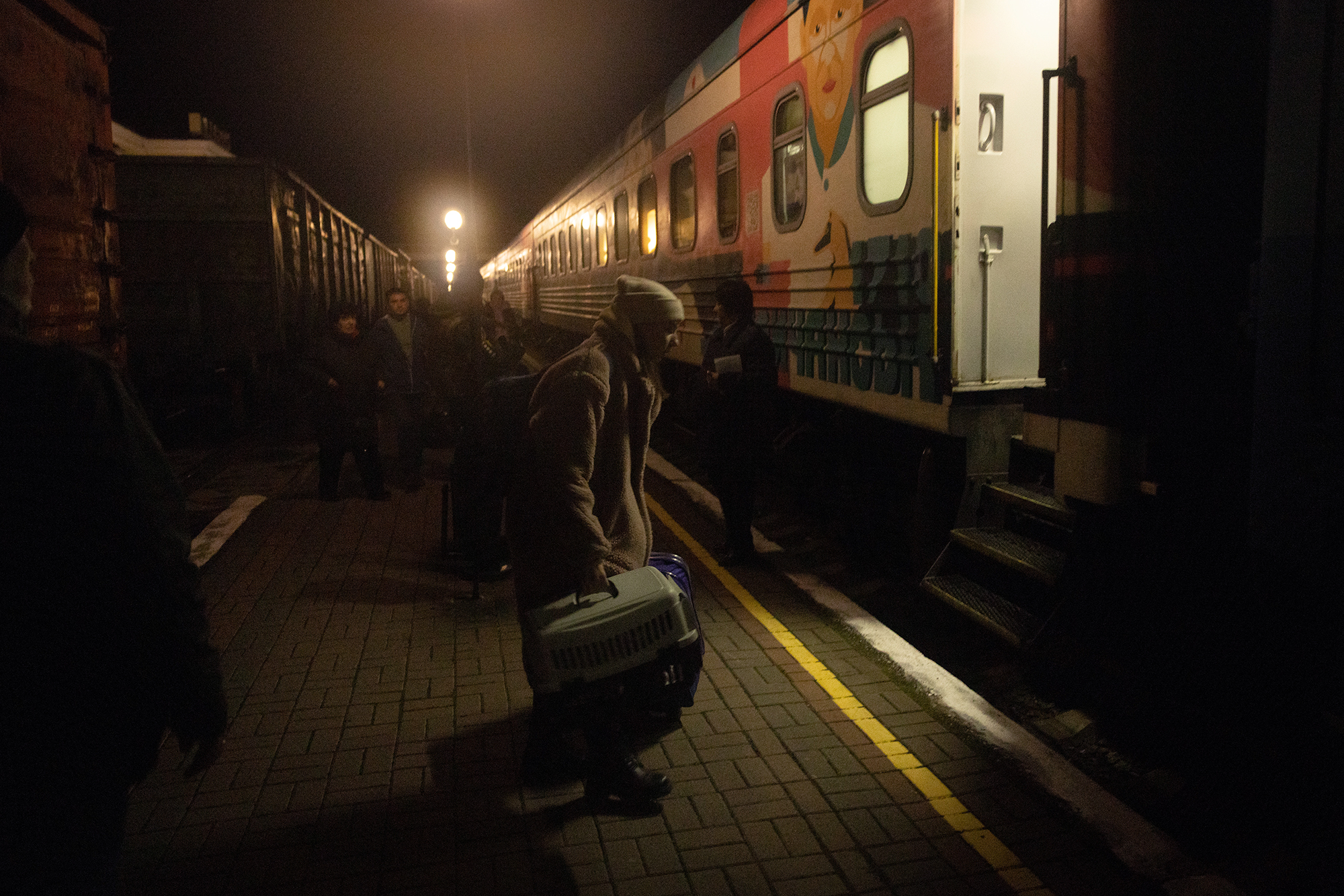 A resident boards an evacuation train on November 21, in Kherson, Ukraine. 