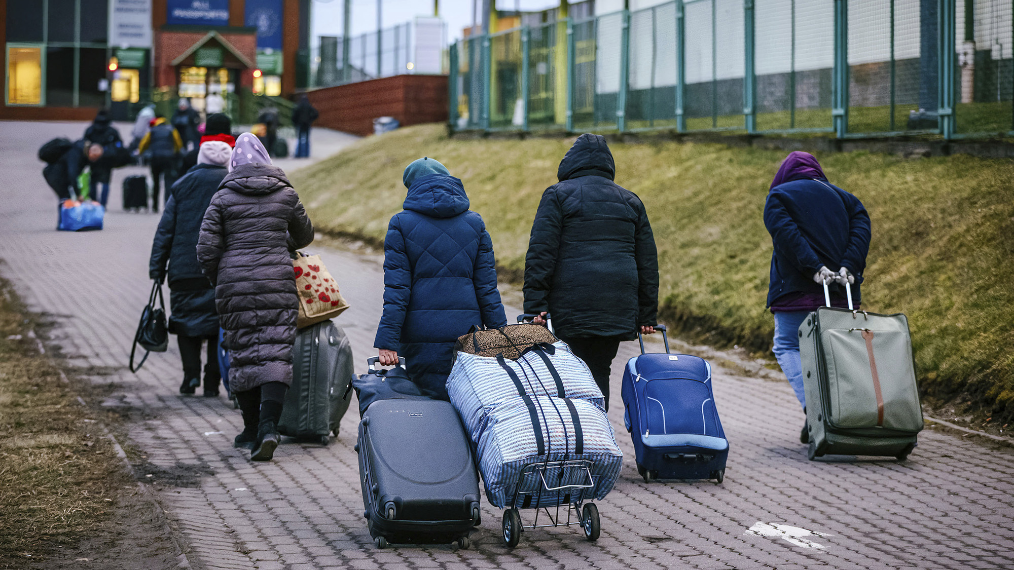 Refugees carrying their luggage are seen going back to Ukraine at the Polish-Ukrainian border crossing in Medyka, Poland on March 12. 