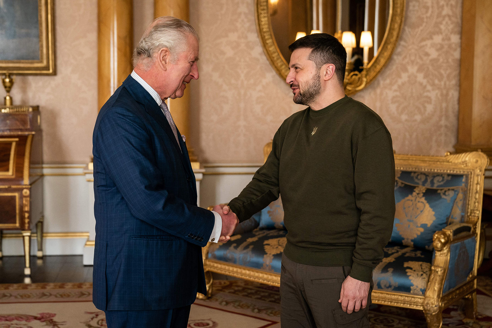 King Charles III, left, shakes hands with Ukraine's President Volodymyr Zelensky as he welcomes him at Buckingham Palace, London, England, on February 8.