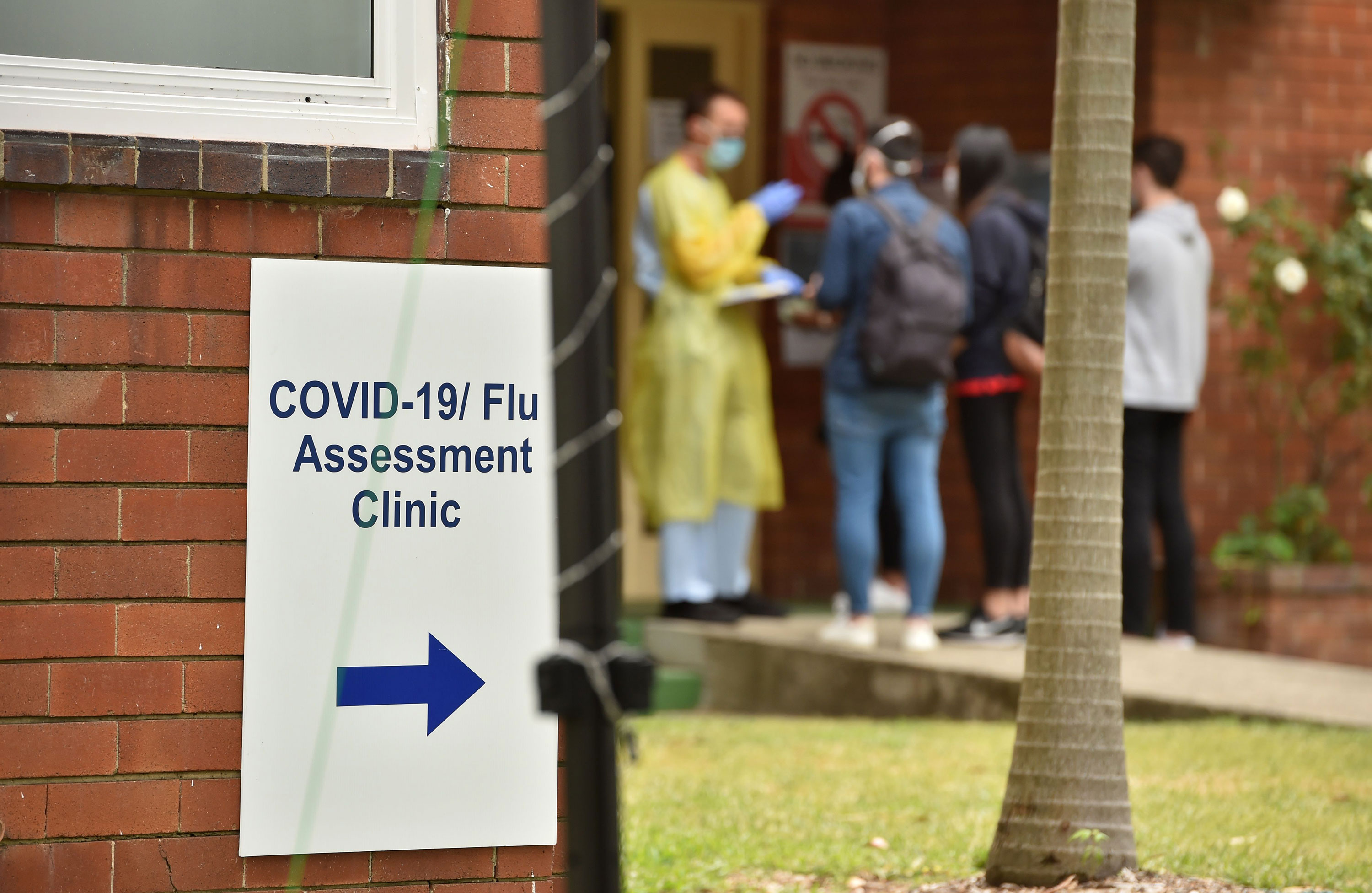 A health worker assists visitors at a Covid-19 testing center in Sydney on March 23.