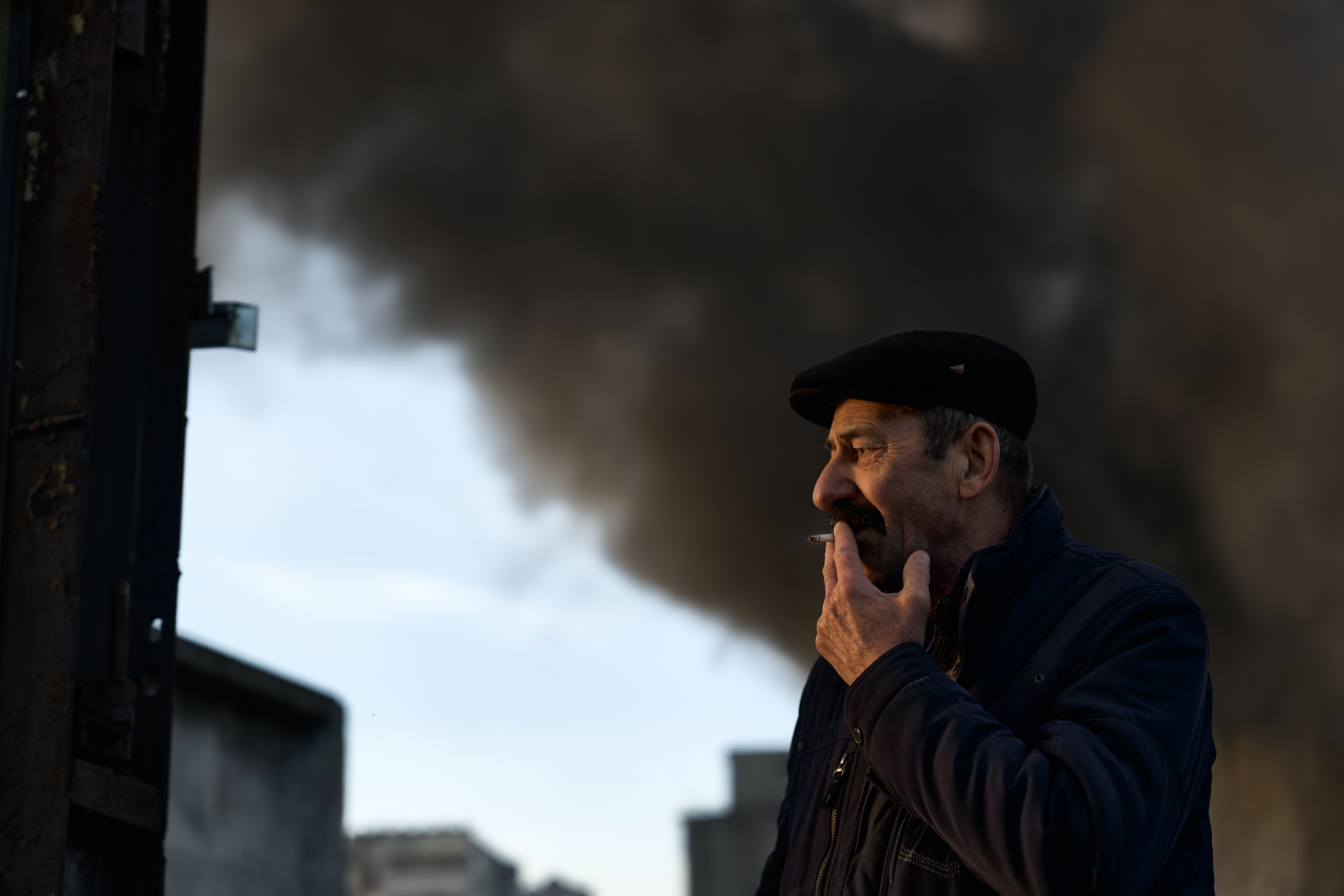 A warehouse guard smokes a cigarette after air attacks on a warehouse in Kyiv, on December 29.