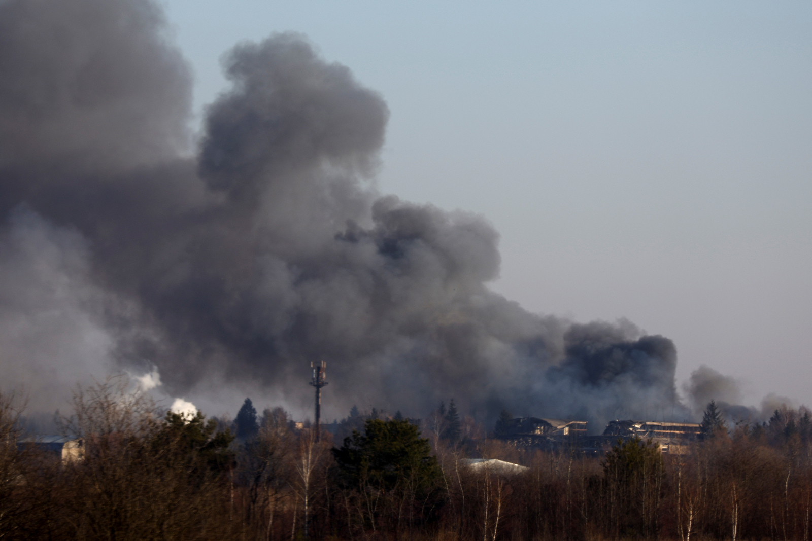 Smoke rises from a factory building near the airport in Lviv, Ukraine, on March 18.