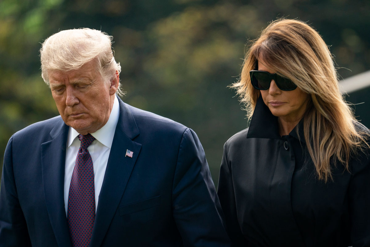 US President Donald Trump and first lady Melania Trump walk to the White House residence as they exit Marine One on September 11.