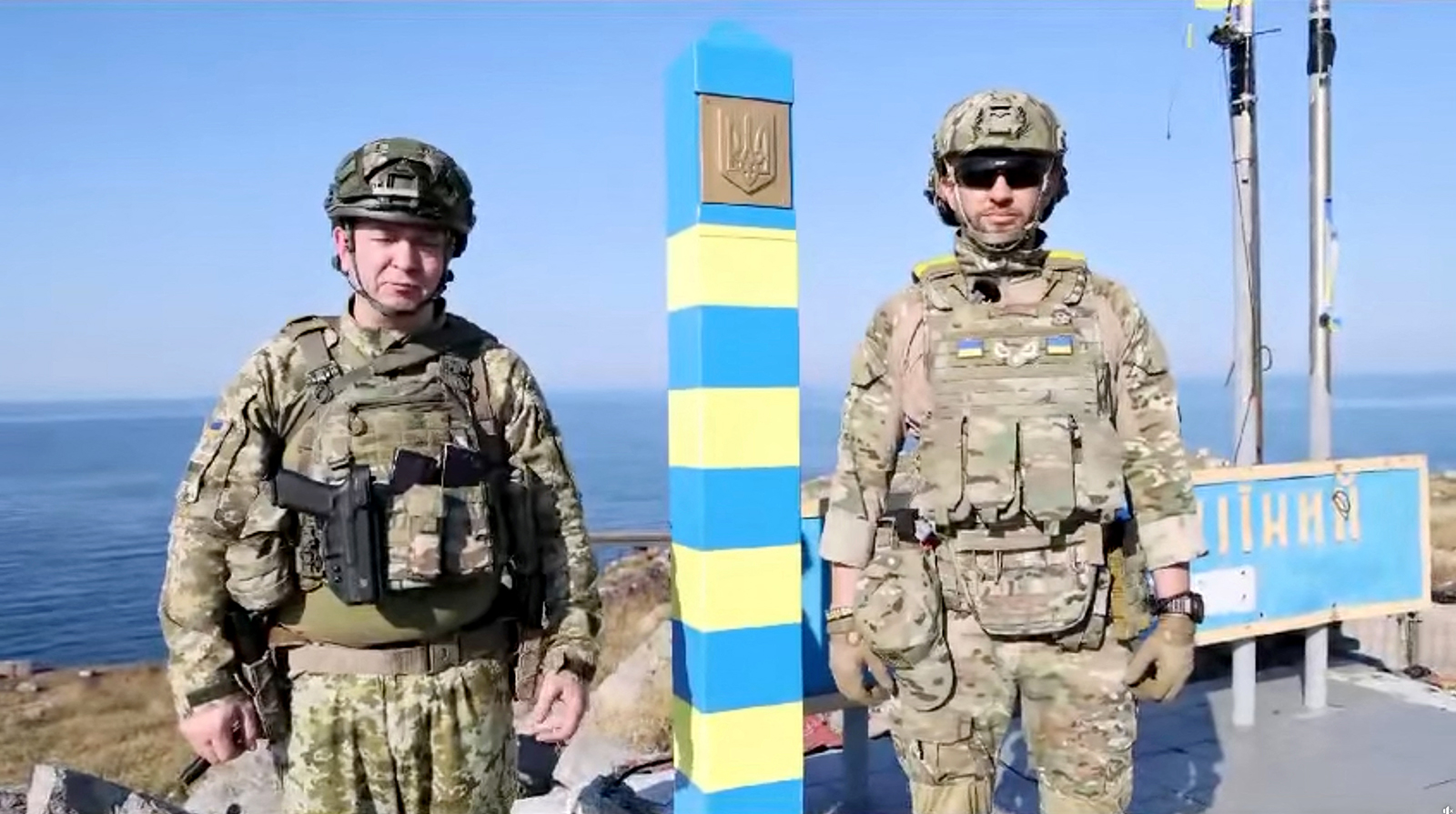 Ukrainian border guards stand next to a newly installed border sign on Snake Island in this screengrab from social media video released on August 12. 
