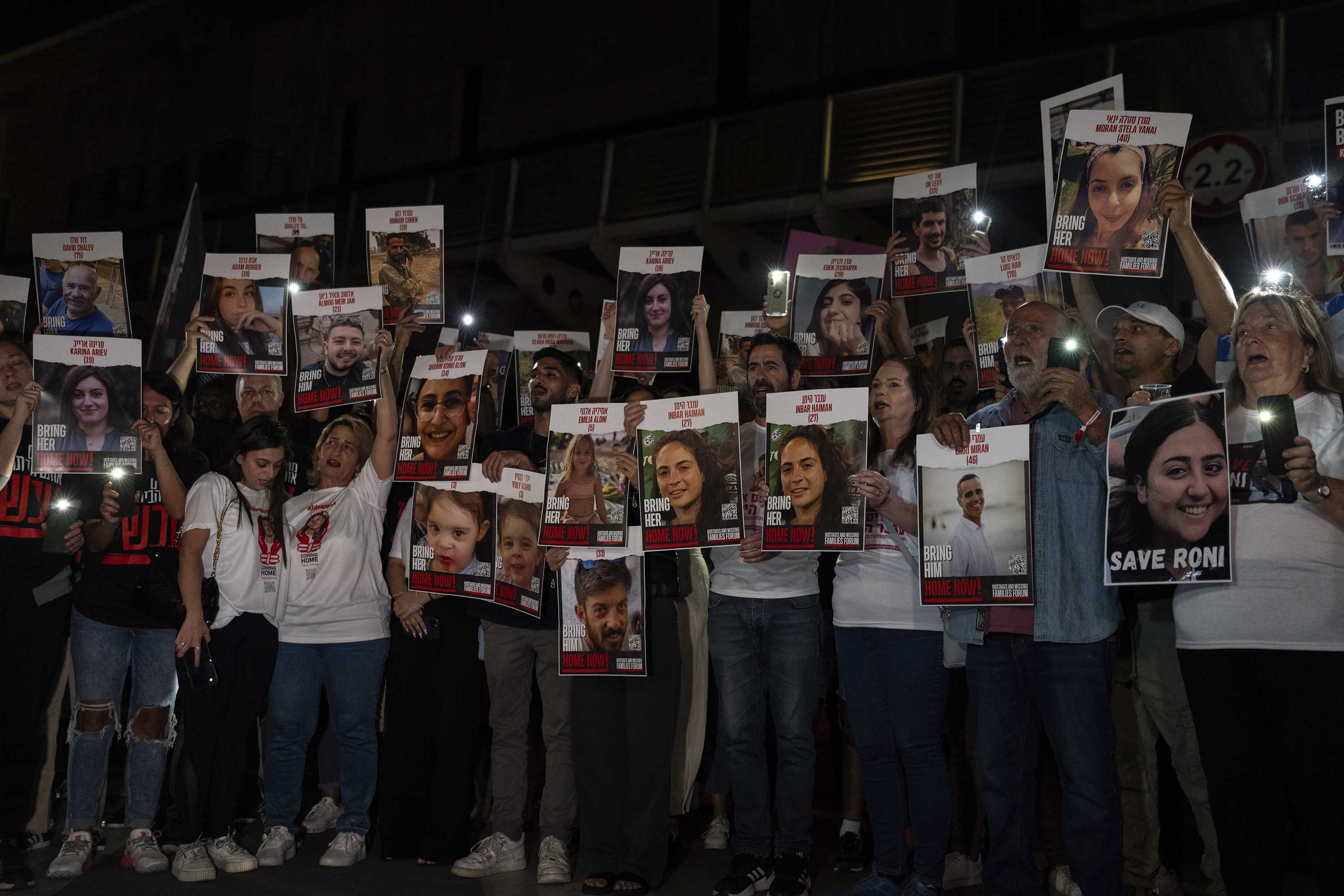People hold photos of loved ones who were kidnapped on October 7 by Hamas militants, during a protest in Tel Aviv, Israel, on October 21. 