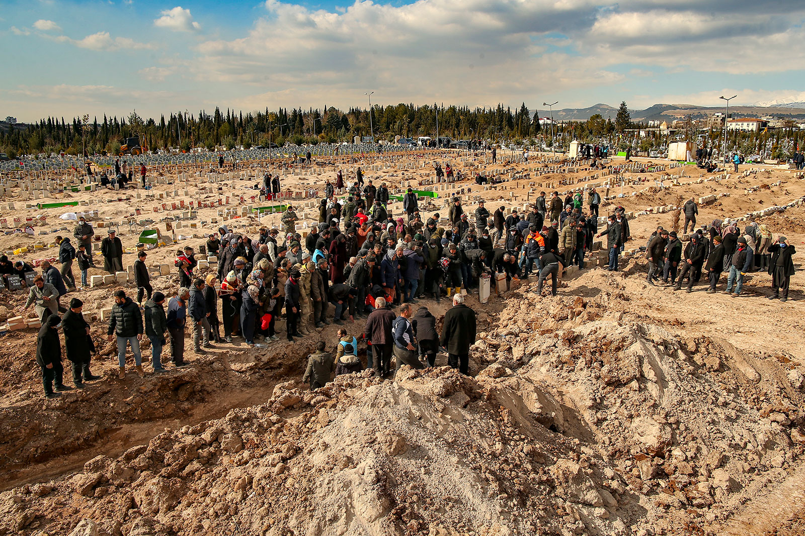 People bury their loved ones who died in the earthquake in Adiyaman, Turkey, on Friday. 
