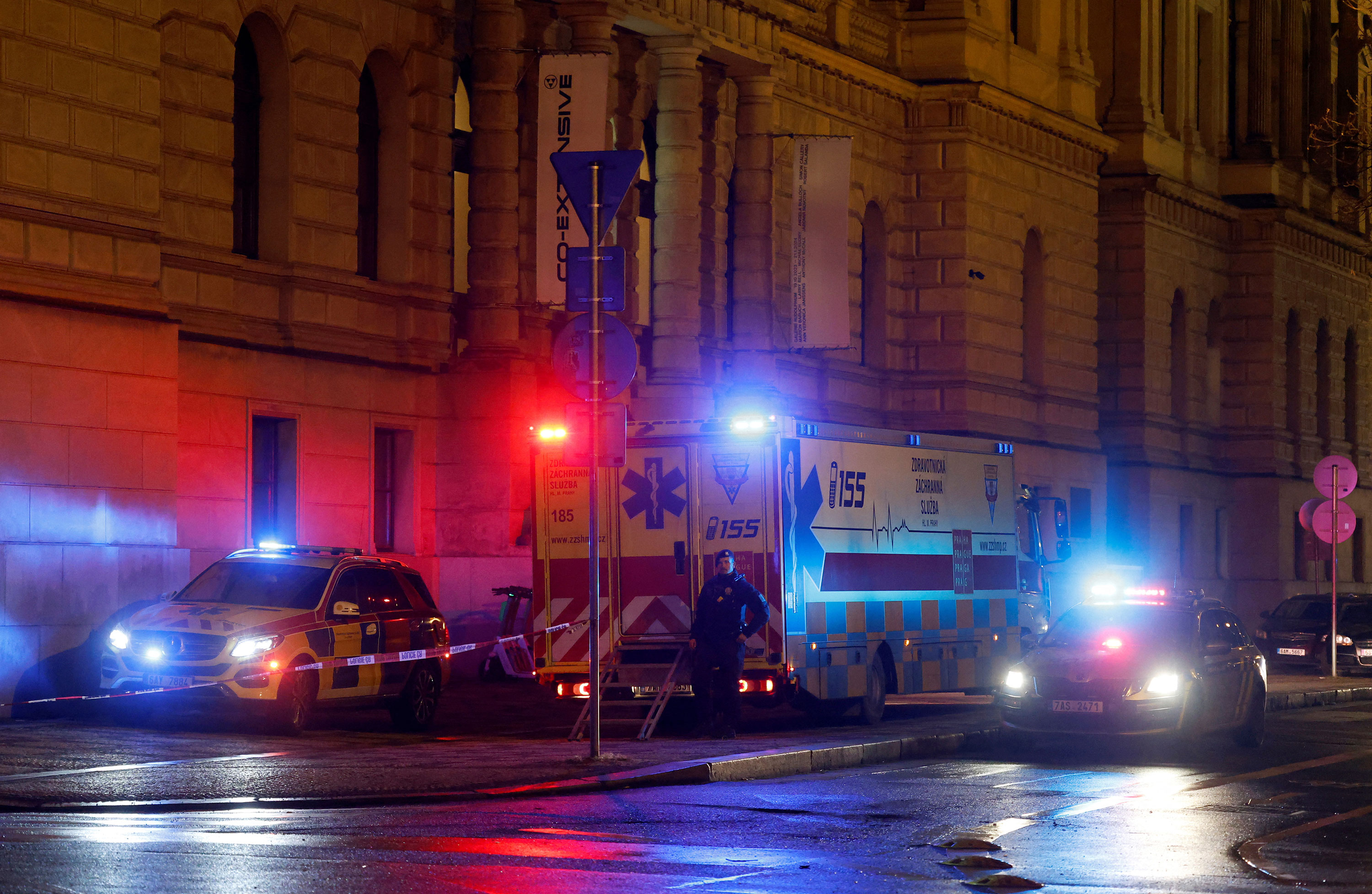 A police officer stands next to ambulances parked near the area of the shooting at Charles University in Prague on Thursday. 