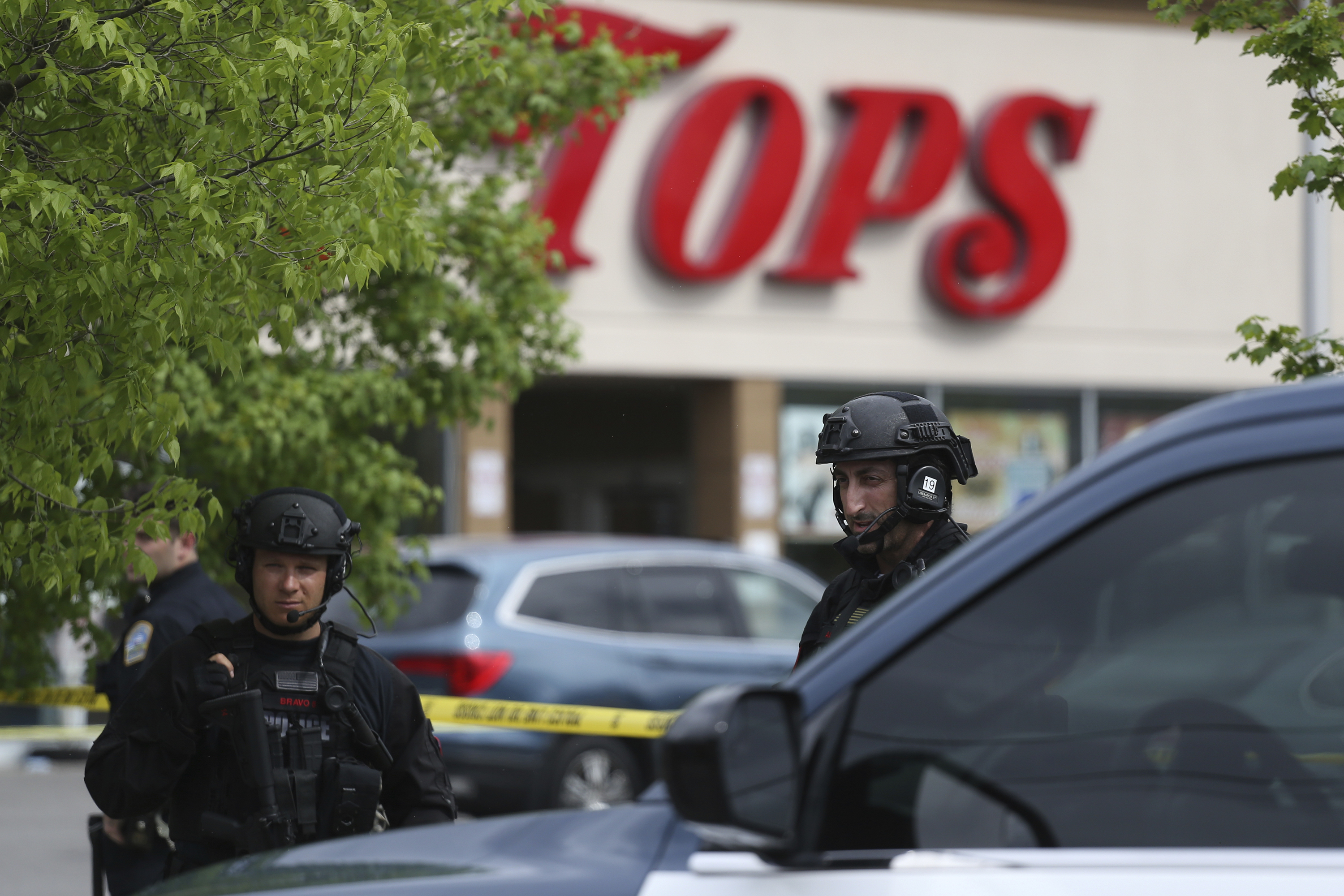 Police secure a perimeter after a mass shooting at a supermarket in Buffalo, NY.