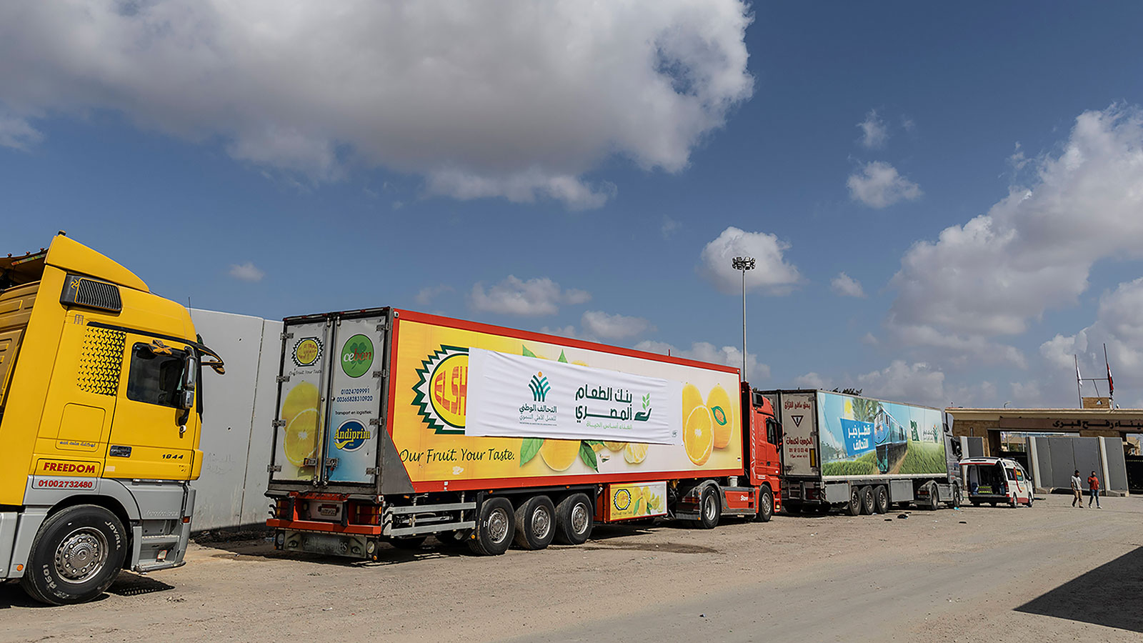 A convoy of trucks carrying aid supplis waits at the Rafah border crossing for clearance to enter Gaza on Thursday, October 19, in North Sinai, Egypt. 