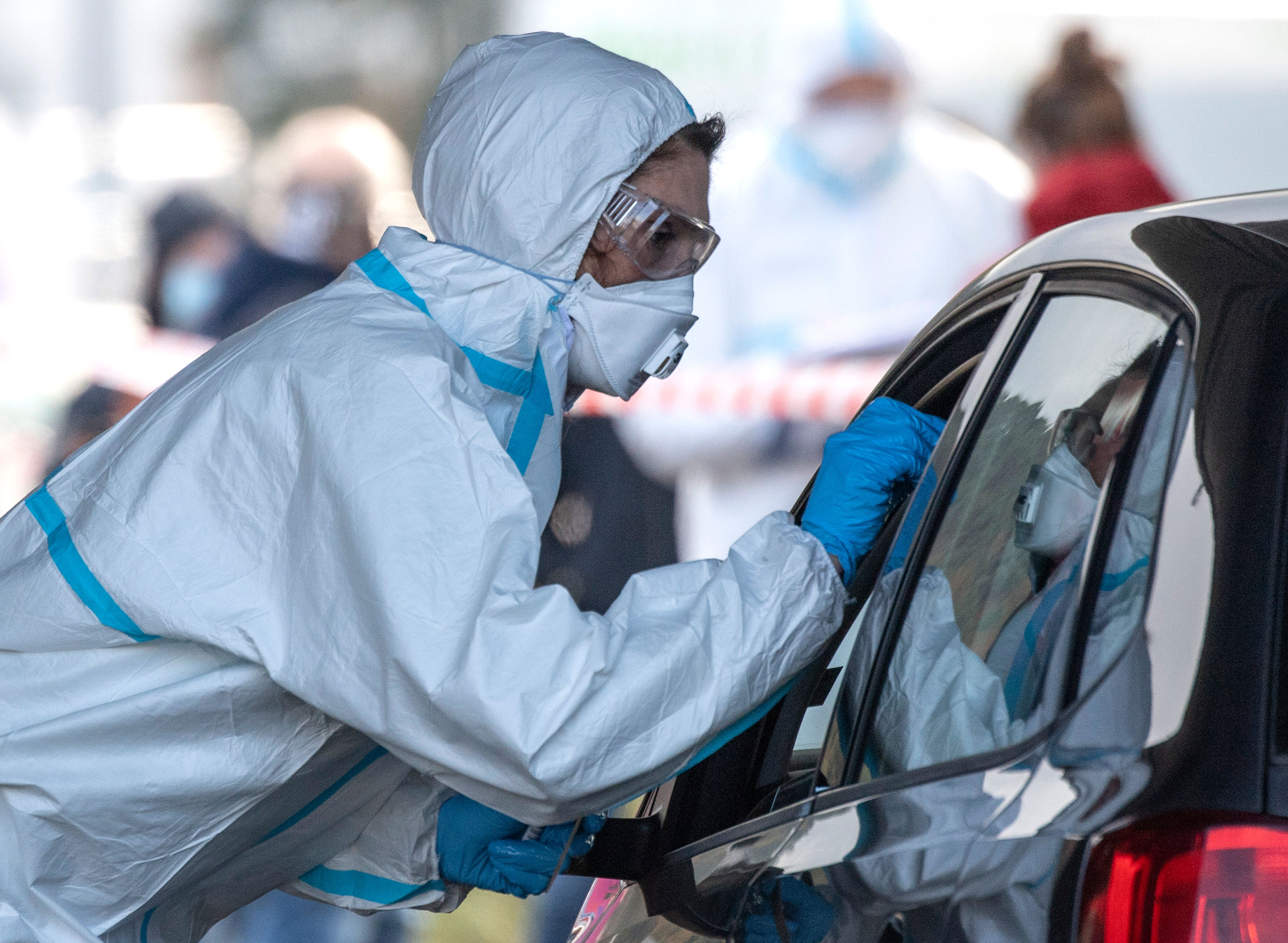 A worker administers Covid-19 tests at a drive-thru testing center in Marburg, Germany, on October 27.