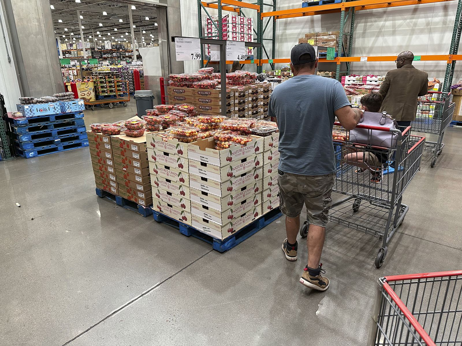 Shoppers peruse product displays through a Costco warehouse on July 11 in Sheridan, CO.