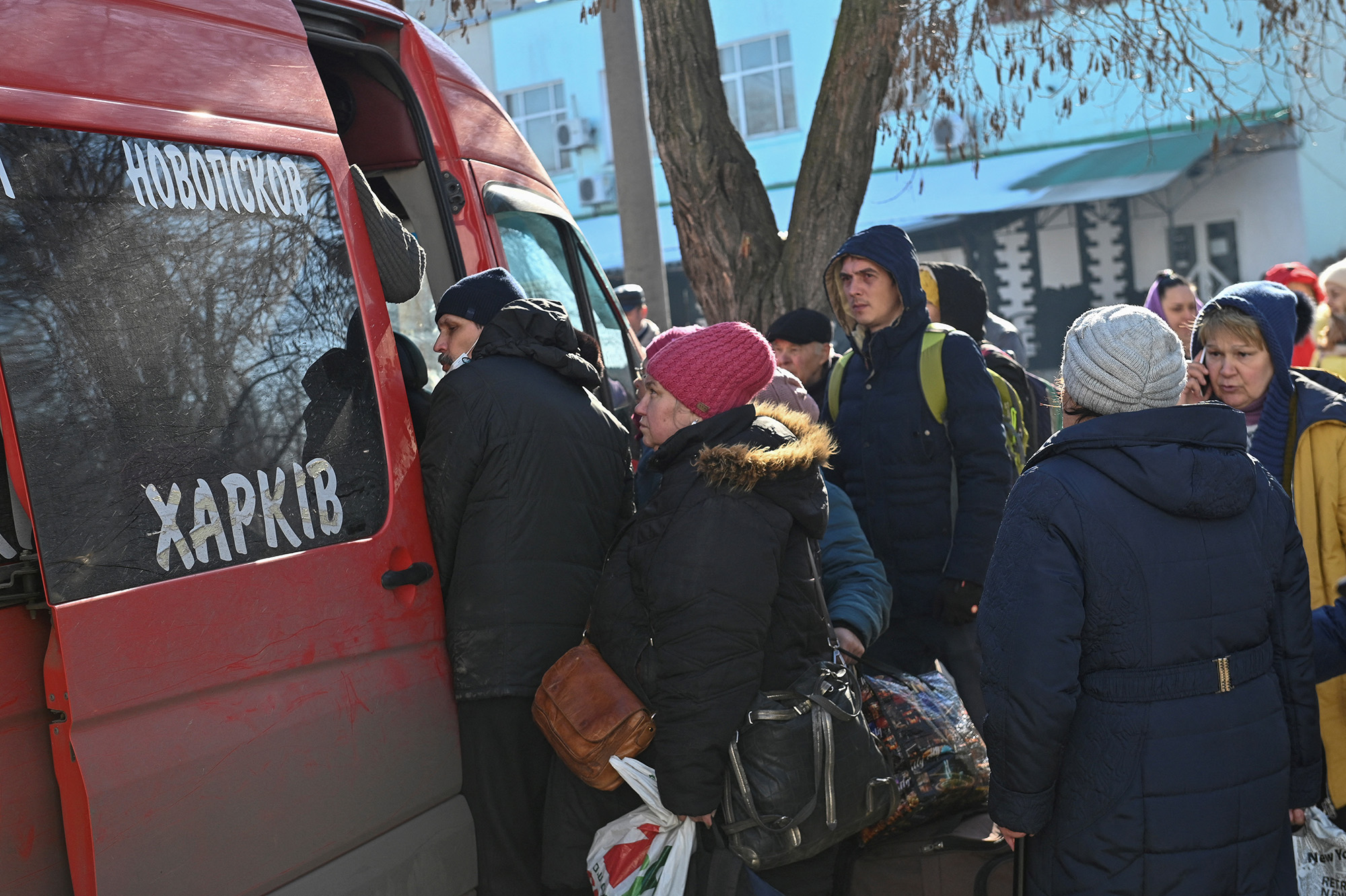 People stand in a queue to board a bus in Sievierodonetsk in the Luhansk region of Ukraine on March 21.