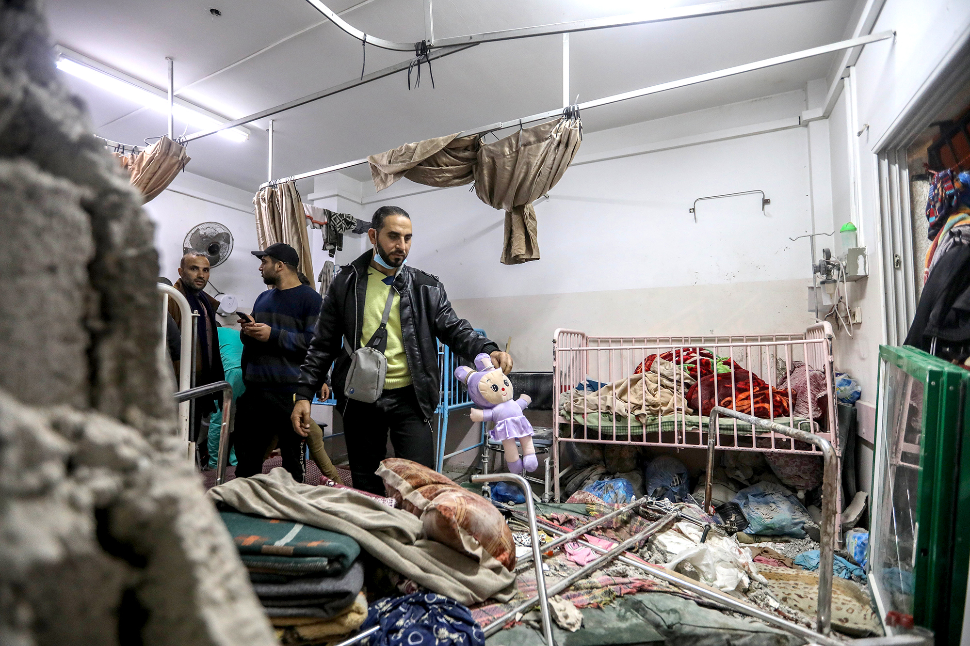 People inspect the damage caused by an artillery shell that hit the maternity hospital inside the Nasser Medical Complex, on December 17, in Khan Younis, Gaza.