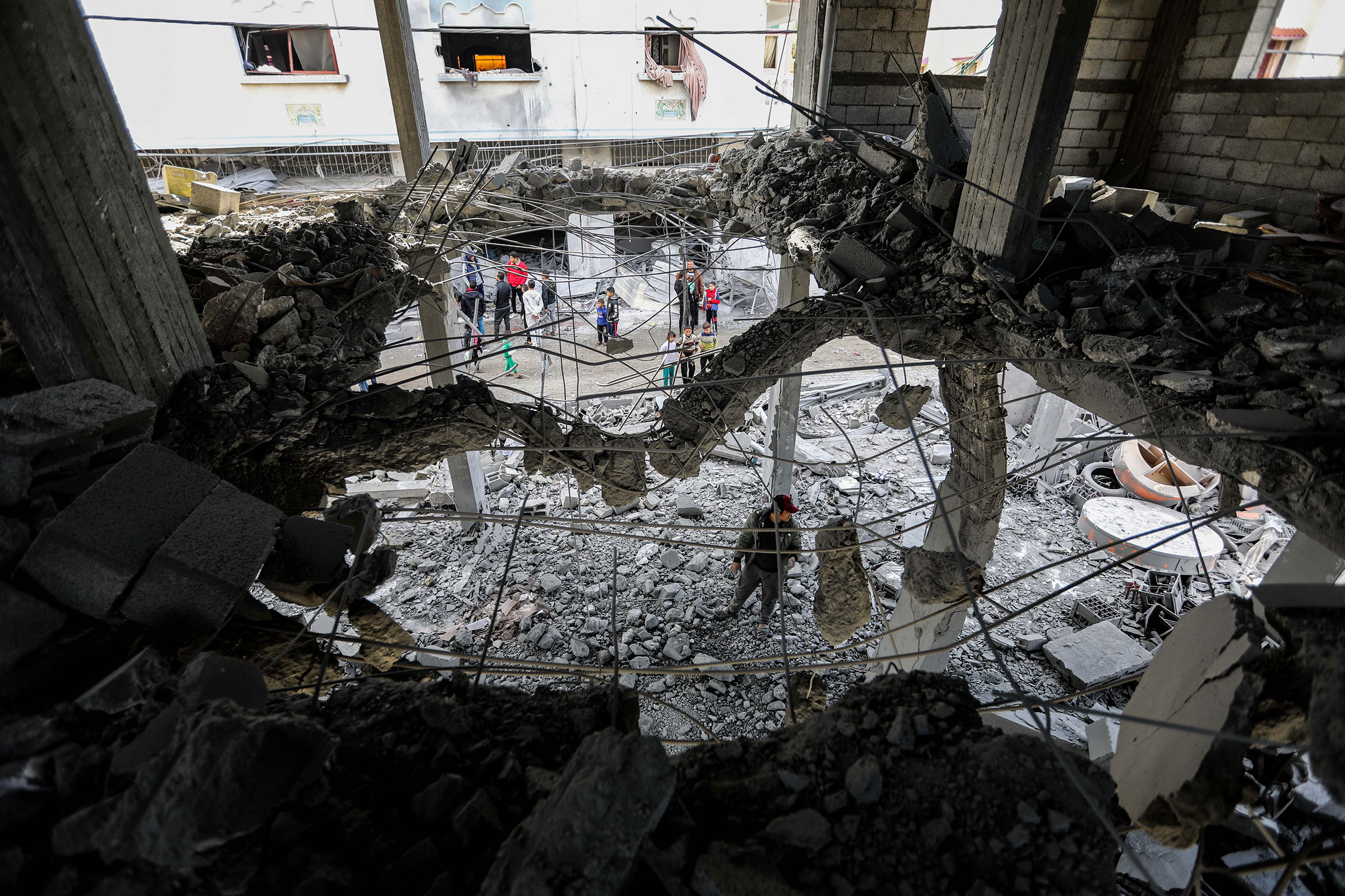  People inspect damage to their homes caused by Israeli air strikes on January 3 in Rafah, Gaza.
