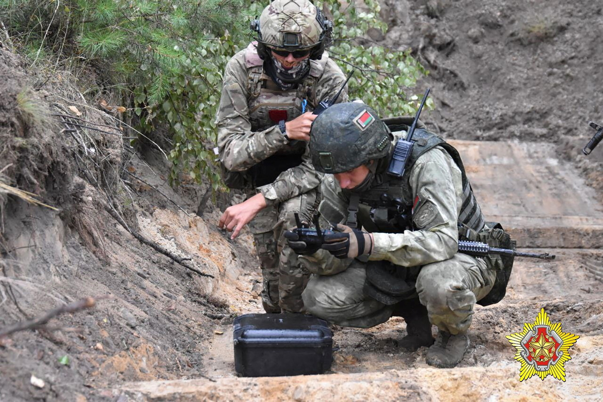 A fighter from Russian Wagner mercenary group and a Belarusian service member take part in a joint training at the Brest military range outside Brest, Belarus, in this still image from a video released on July 20.