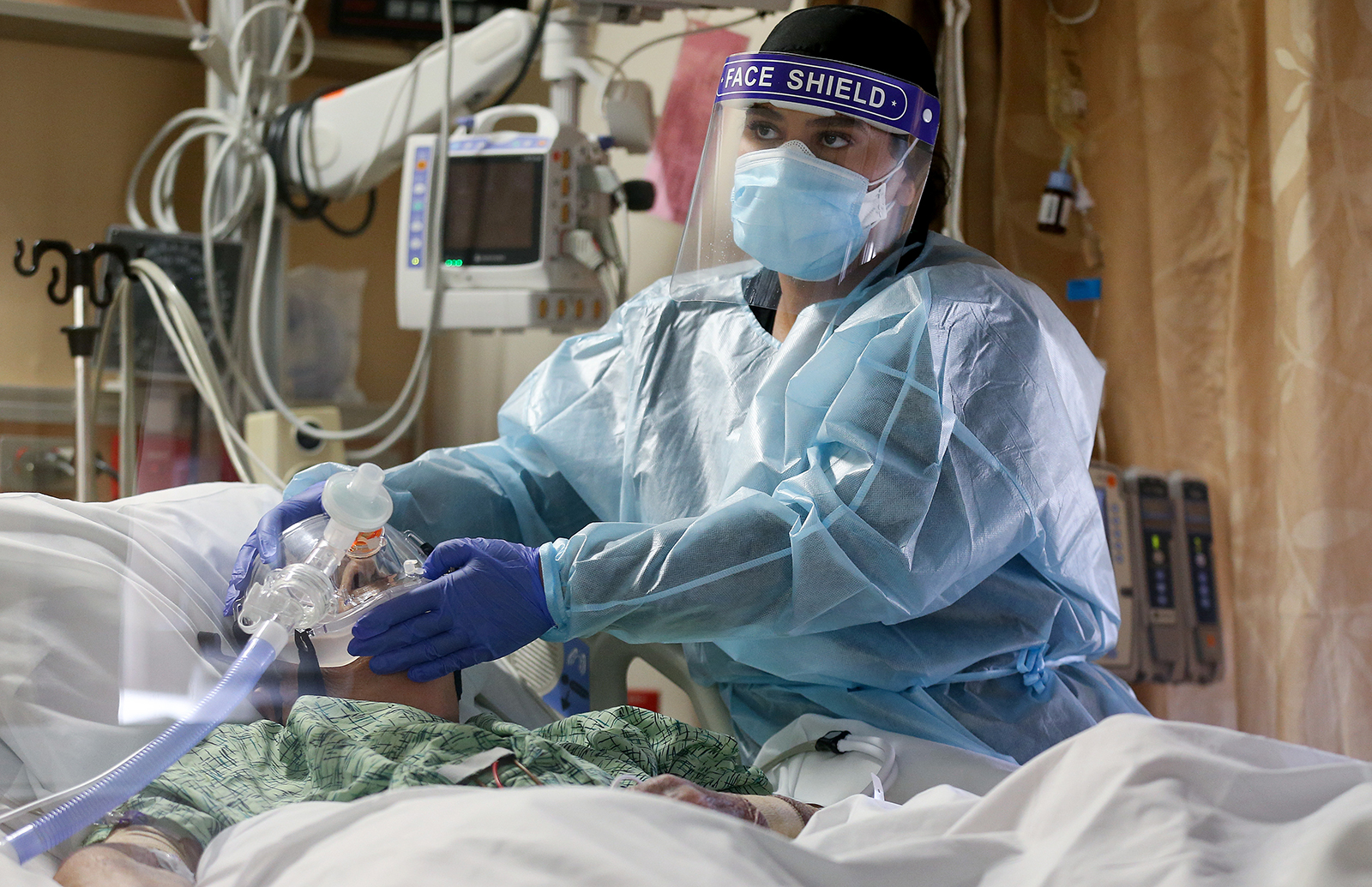 A clinician cares for a Covid-19 patient in the Intensive Care Unit at Providence St. Mary Medical Center on December 23,  in Apple Valley, California. 
