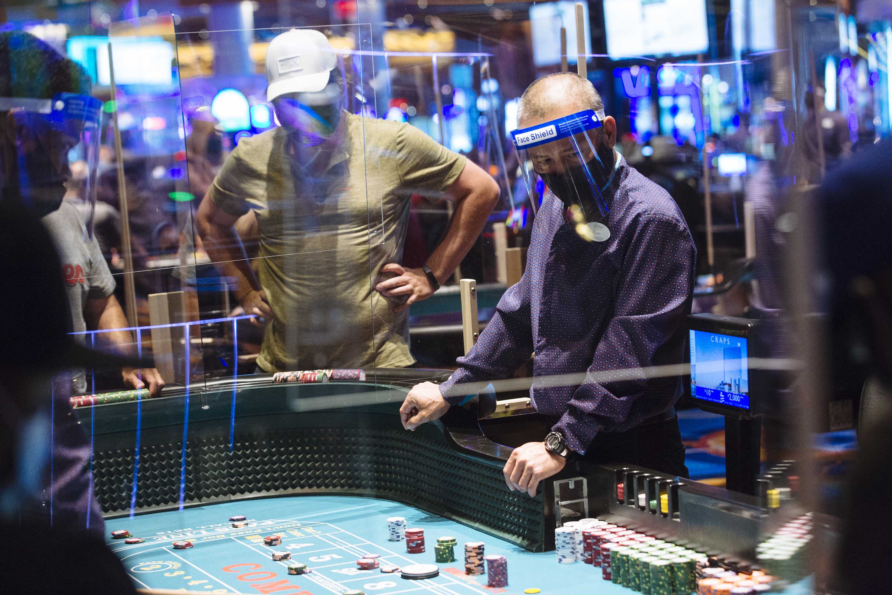 An employee wears a protective mask and face shield while overseeing the craps table at the Ocean Casino Resort in Atlantic City, New Jersey, in July 2020. 