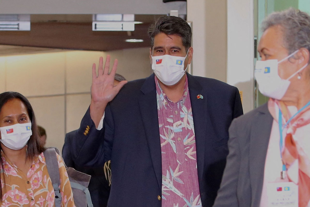 Palau President Surangel Whipps waves after arriving at the Taoyuan International Airport on March 28.