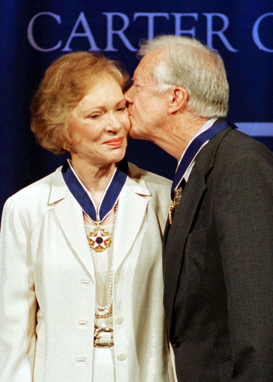 Rosalynn gets a kiss from her husband after they were awarded Presidential Medals of Freedom in 1999. The Carters were presented with the medals for the work they have done since leaving the White House in 1980. 