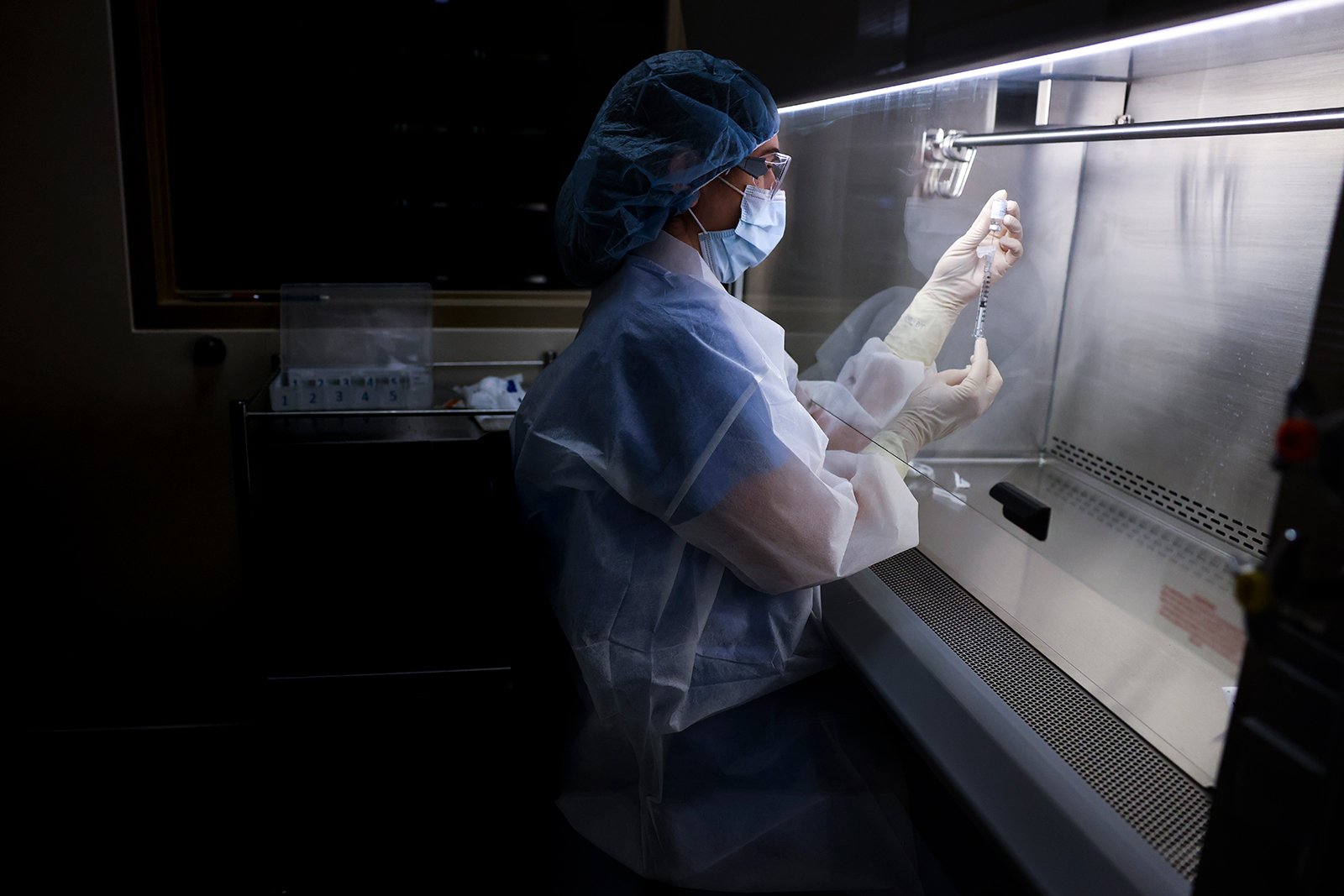 A pharmacy technician prepares a dose of the Johnson & Johnson COVID-19 vaccine for a clinical trial in Aurora, Colorado, on December 15, 2020.