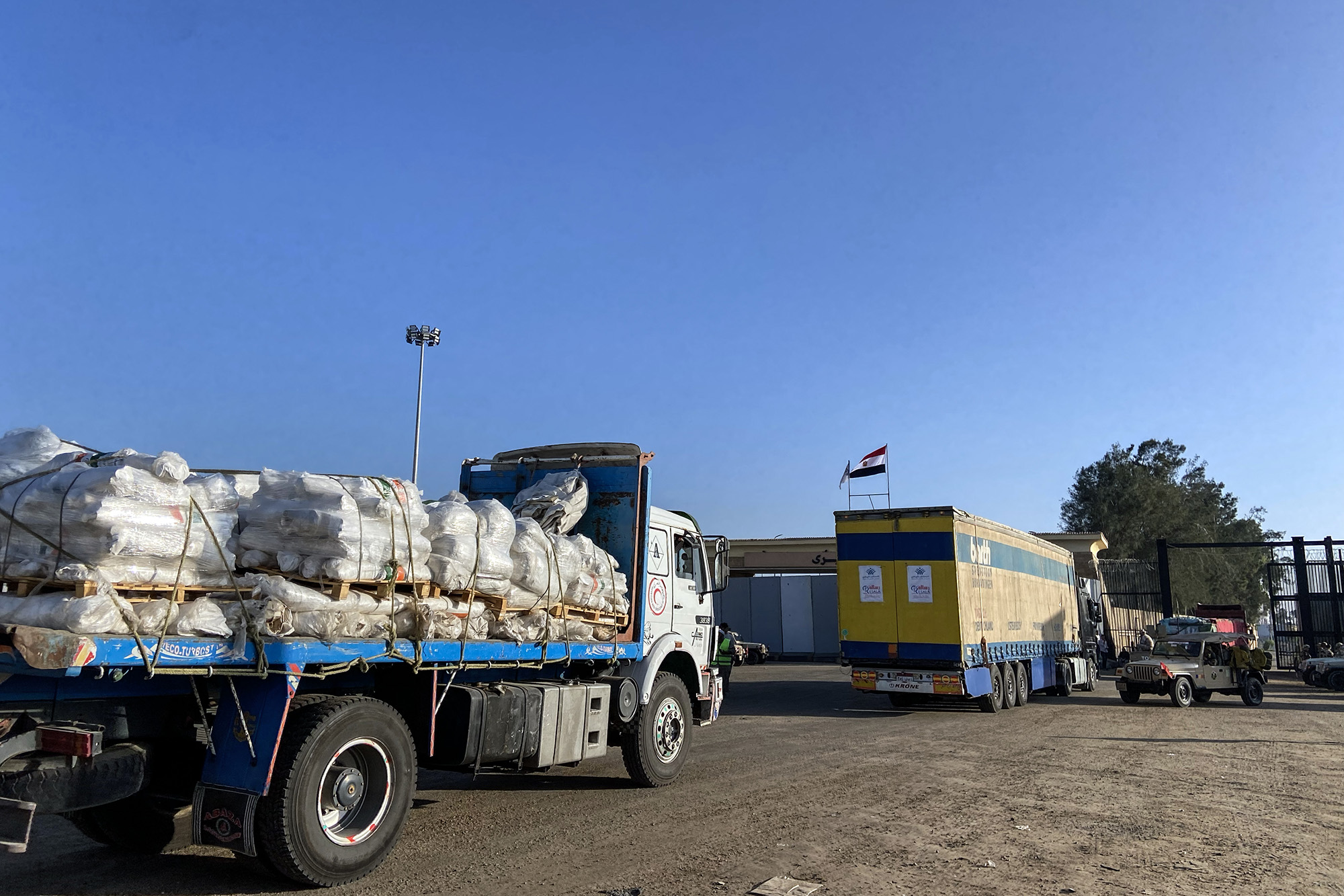 Aid convoy trucks cross the Rafah border from the Egyptian side on November 6, in Rafah, Egypt.