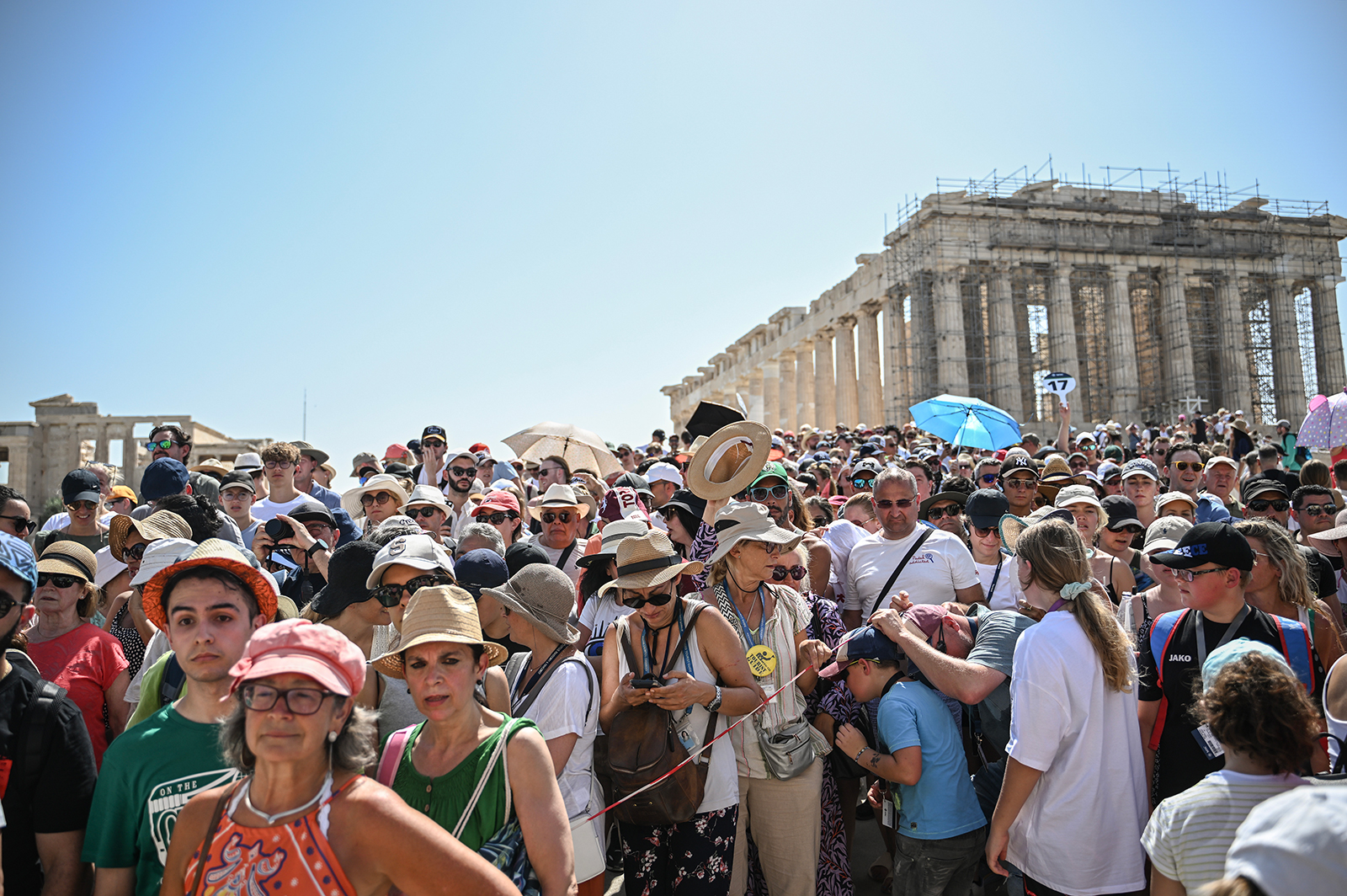 Tourists visit the Parthenon Temple during a hot day in Athen, Greece, on July 14.