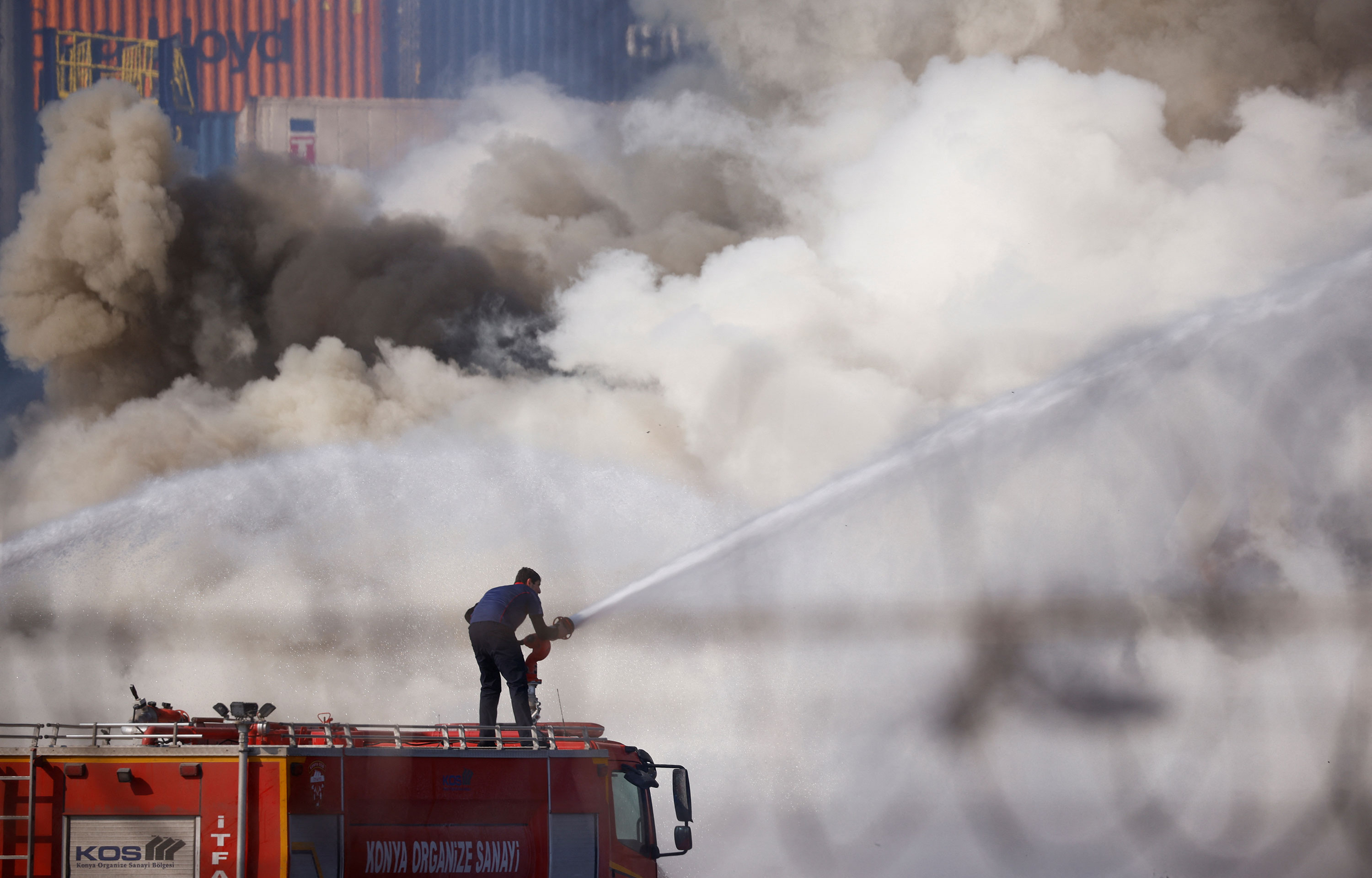 A firefighter works at the port on Wednesday.