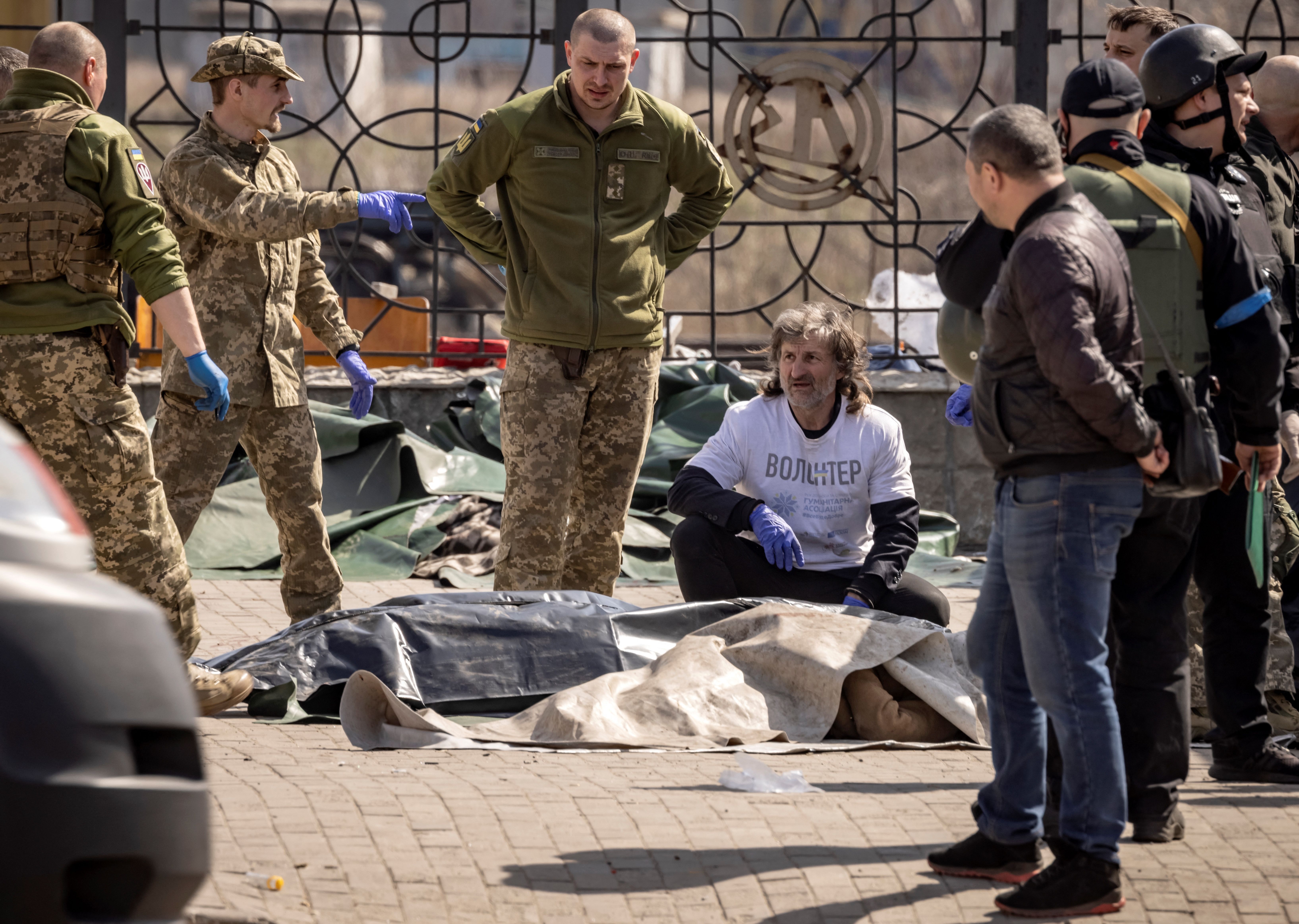 Ukrainian soldiers clear out bodies after a rocket attack at a train station in Kramatorsk, Ukraine, on April 8.