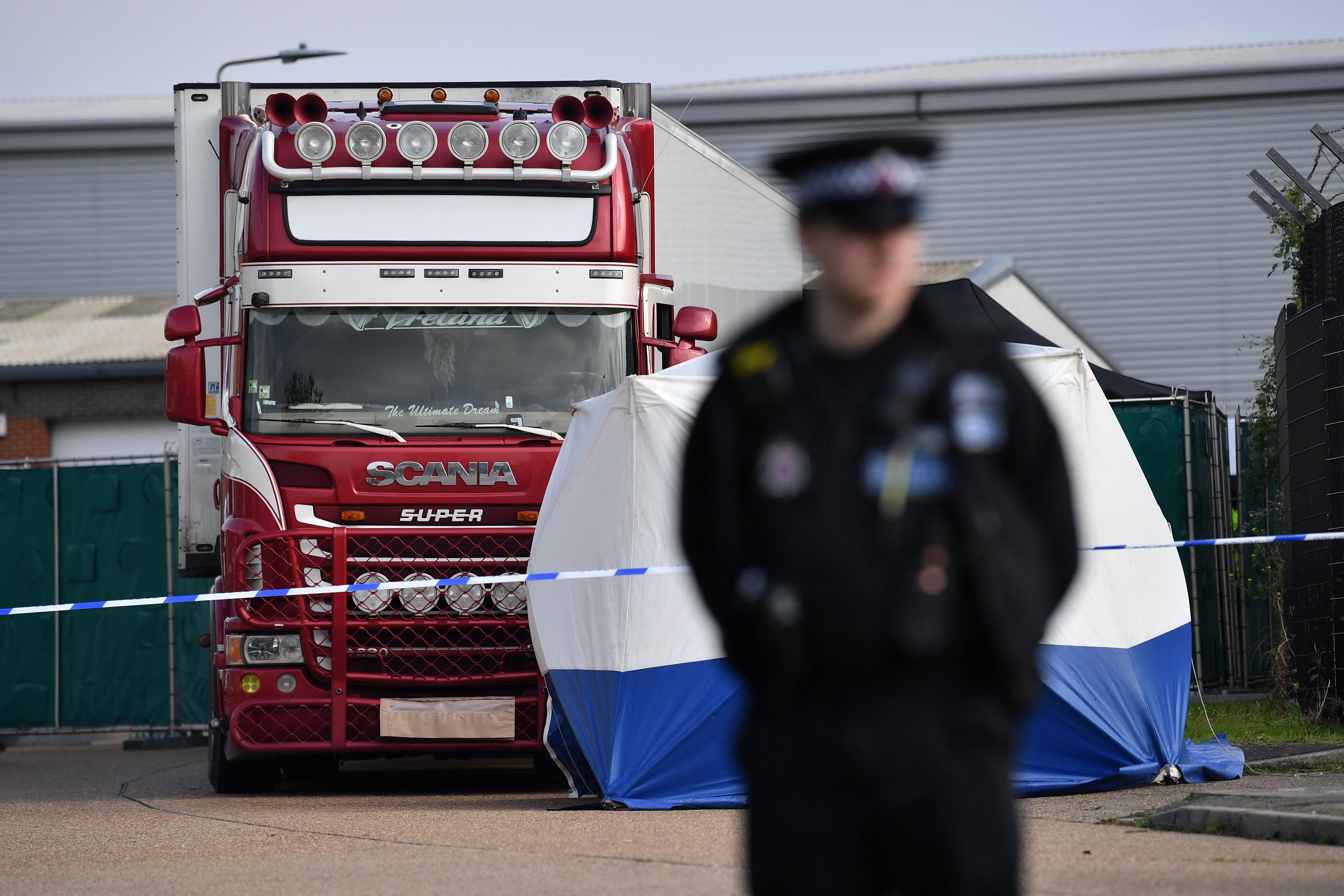 A police officer secures the cordon at at the scene where a lorry, believed to have originated from Bulgaria, and found to be containing 39 dead bodies, was discovered at Waterglade Industrial Park in Grays, east of London, on Wednesday.
