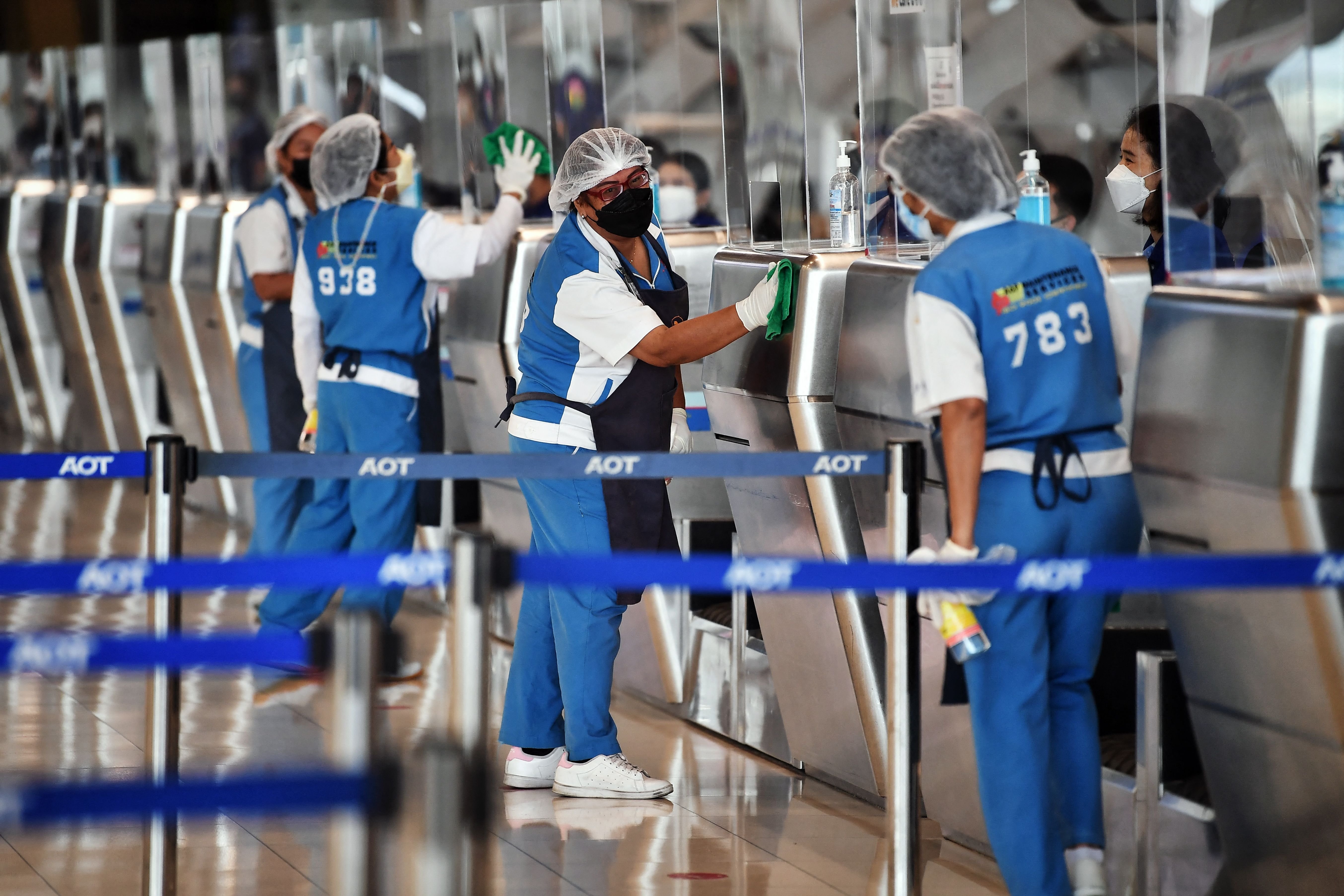 Airport staff clean the check-in kiosks at Suvarnabhumi International Airport as officials rehearse reopening procedures to welcome the first group of vaccinated tourists without quarantine on November 1, in Bangkok on October 27th, 2021.