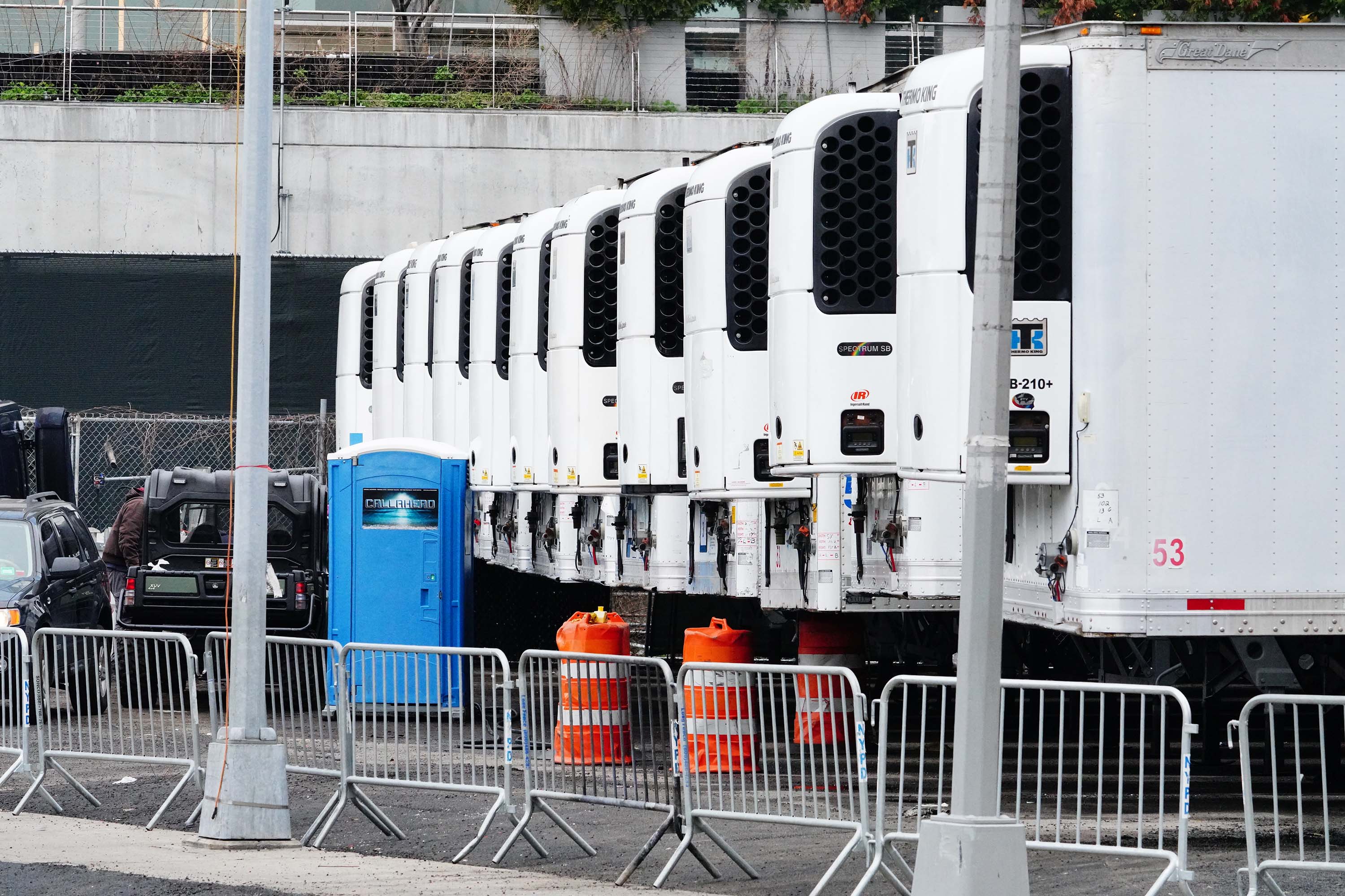 Refrigeration units intended as makeshift morgues are seen parked behind Belleview Hospital Center in New York City on March 30.