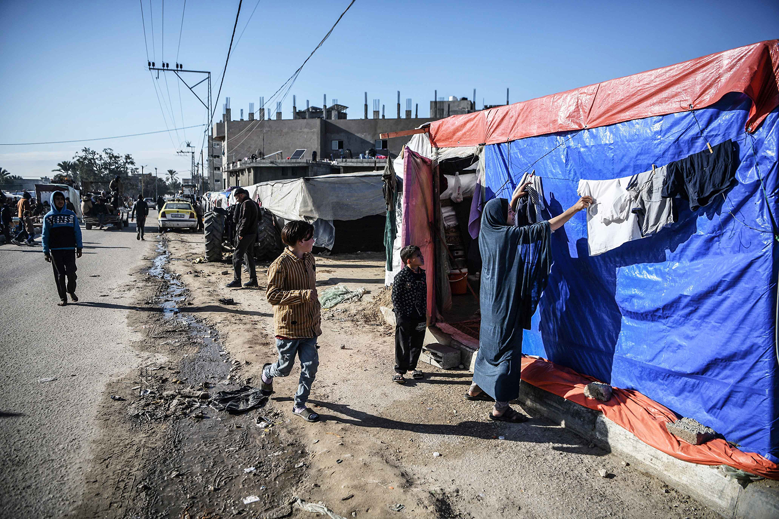 Displaced Palestinians are pictured along a road near their makeshift tent in Rafah, Gaza on February 4.
