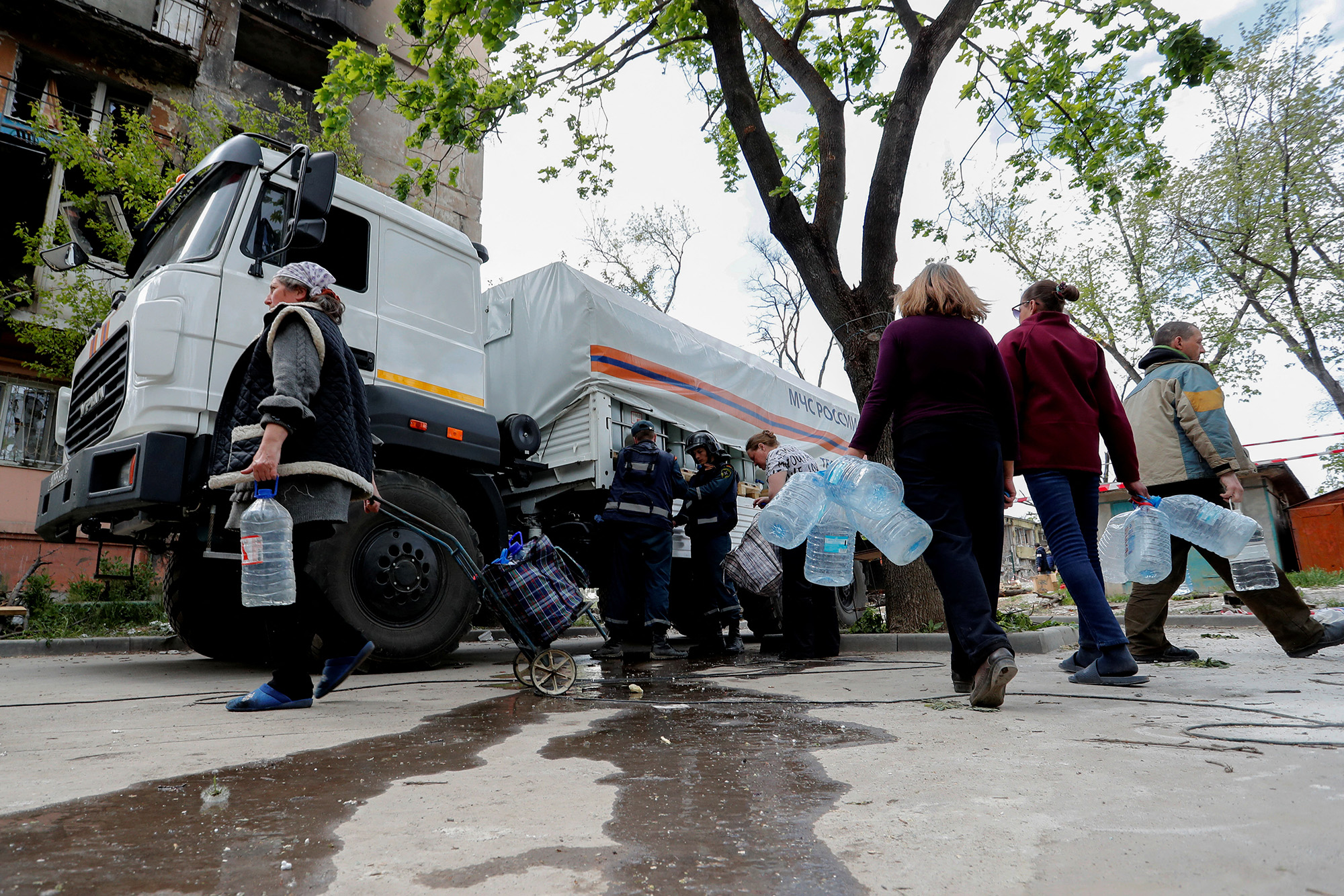 Local residents gather near a tanker to collect potable water in Mariupol, Ukraine, on May 11.