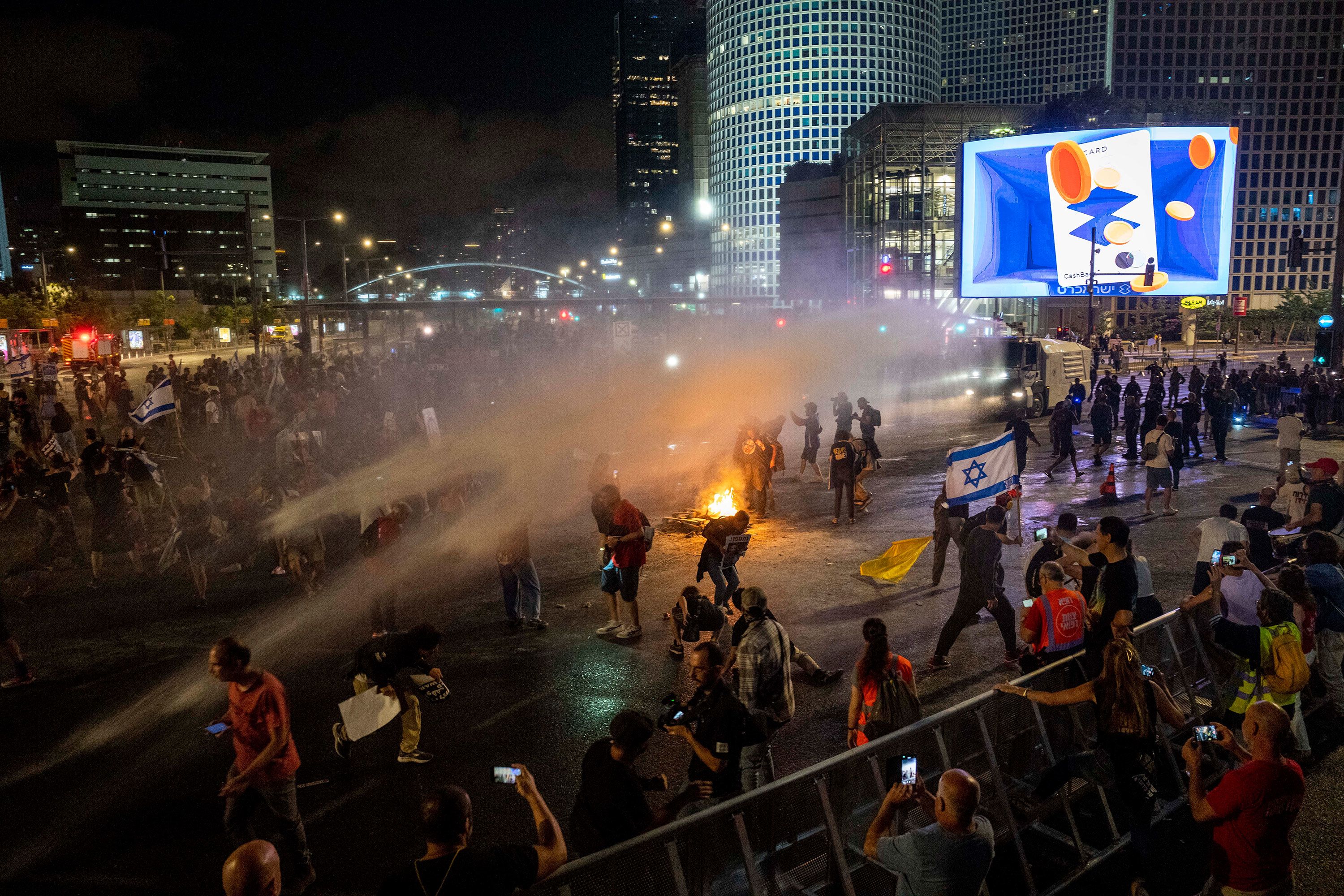 Police use water cannon to disperse demonstrators during a protest against Israeli Prime Minister Benjamin Netanyahu's government in Tel Aviv, Israel, on May 25, 2024. 